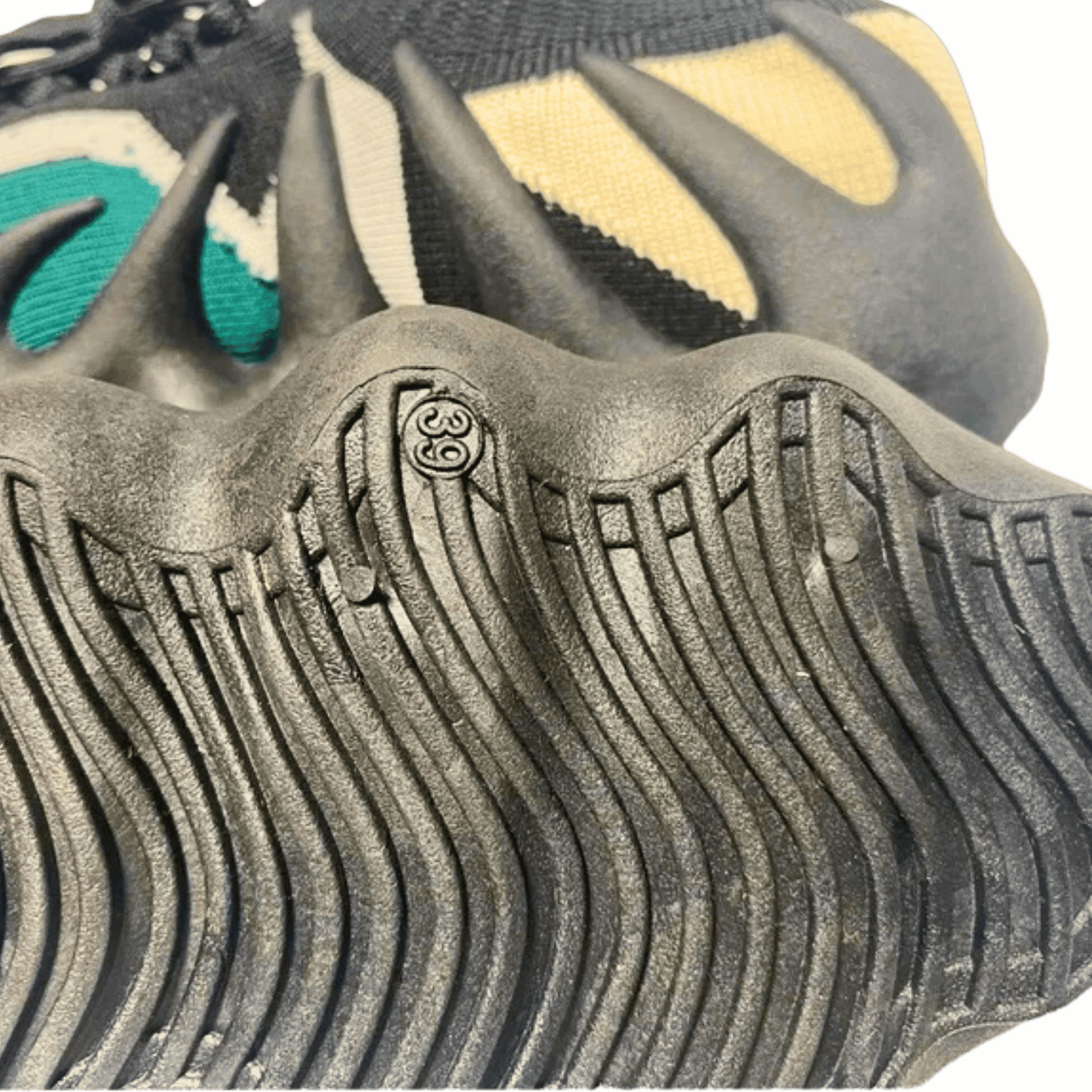 Close-up of a shoe sole with unique tread pattern and brand logo.