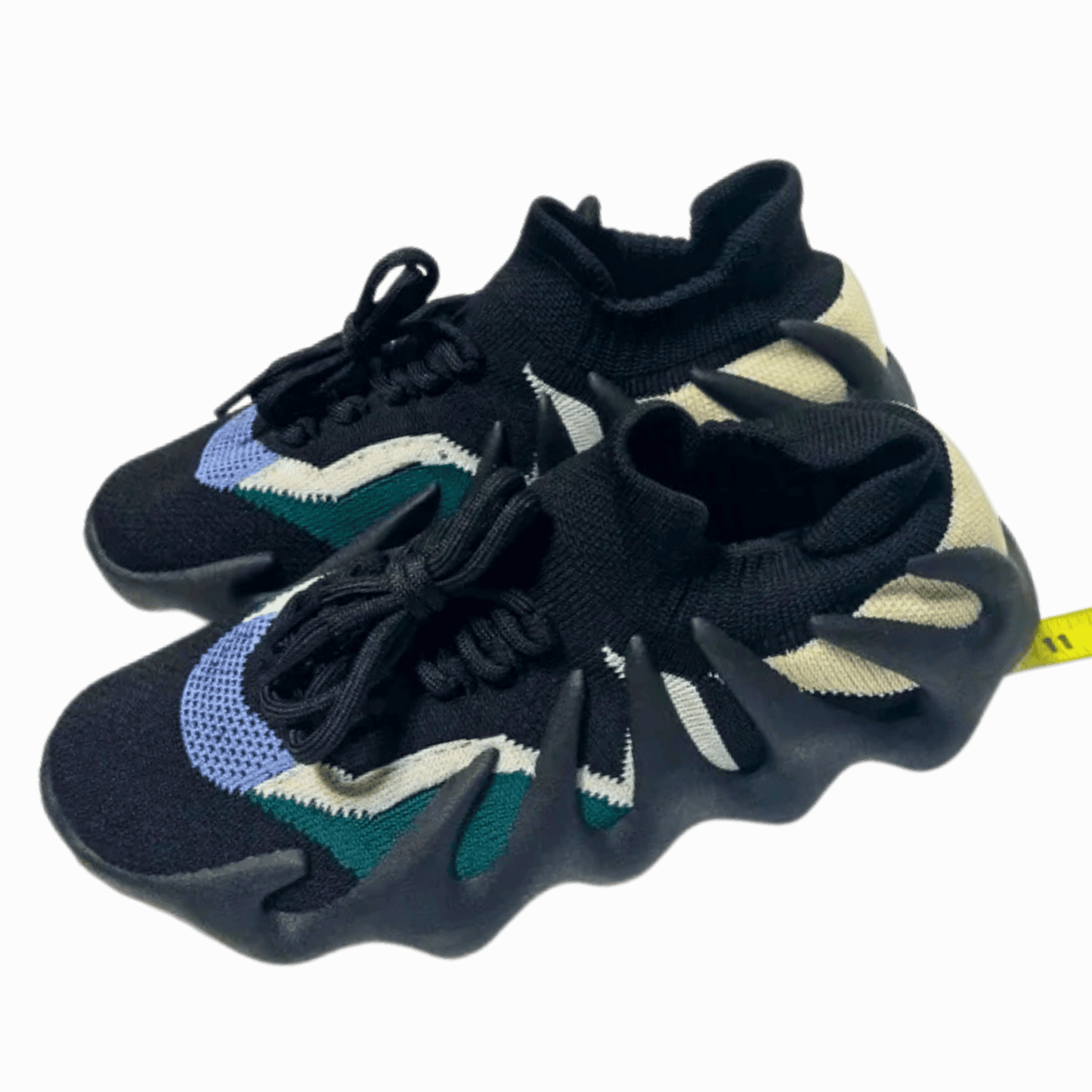 Black and blue athletic shoes with a yellow tag on a dark background