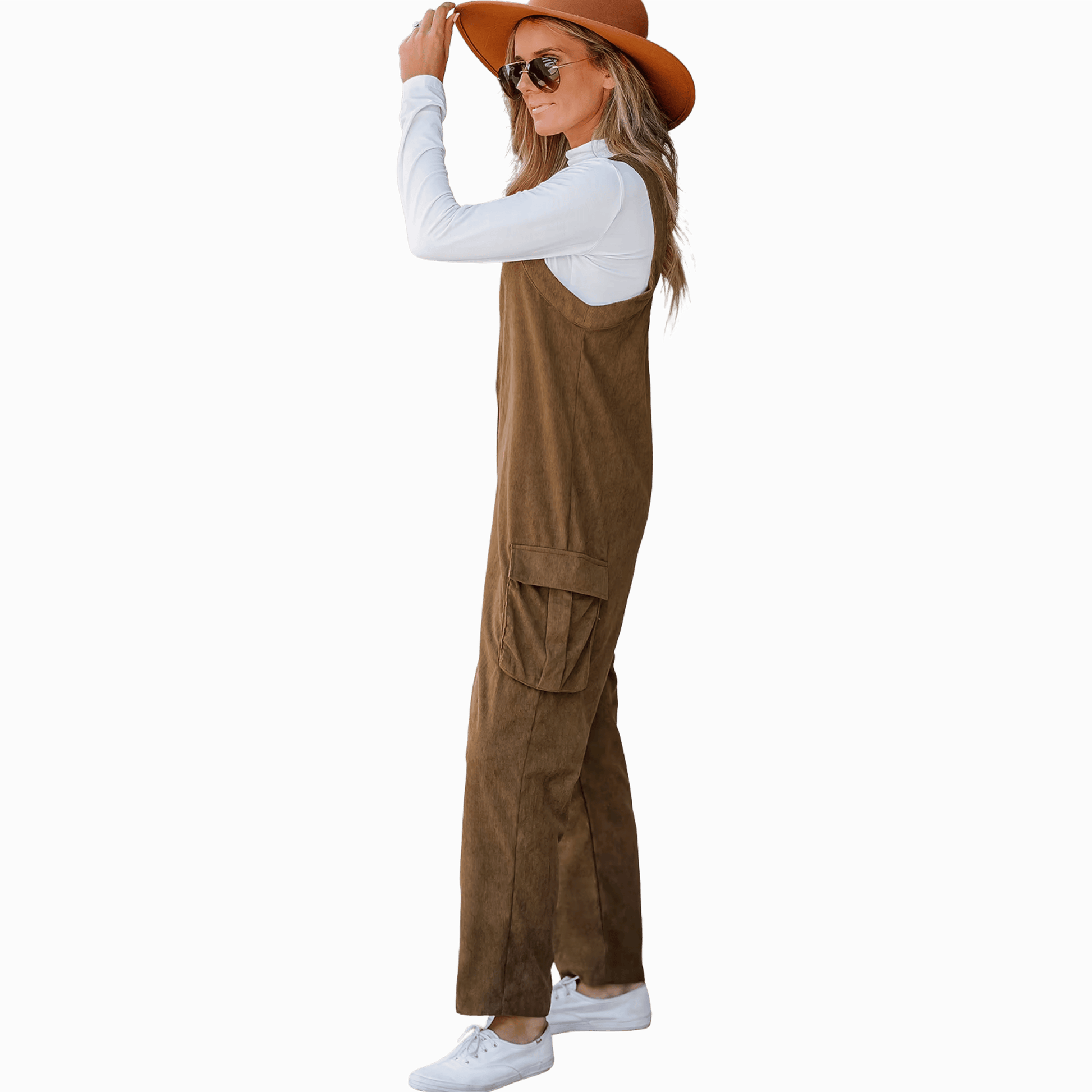 Woman wearing a brown jumpsuit and hat on a gray background