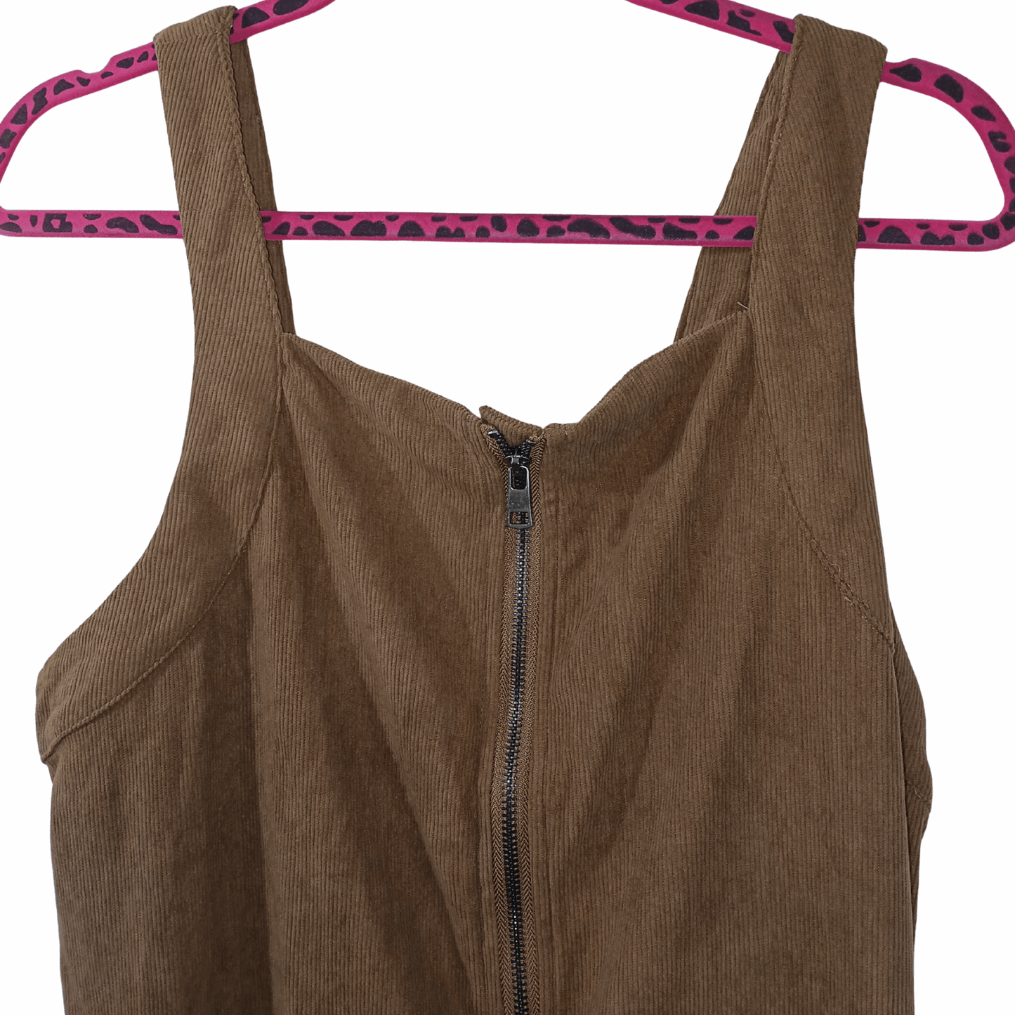Brown corduroy dress with a zipper on a pink hanger with leopard print pattern against a gray background
