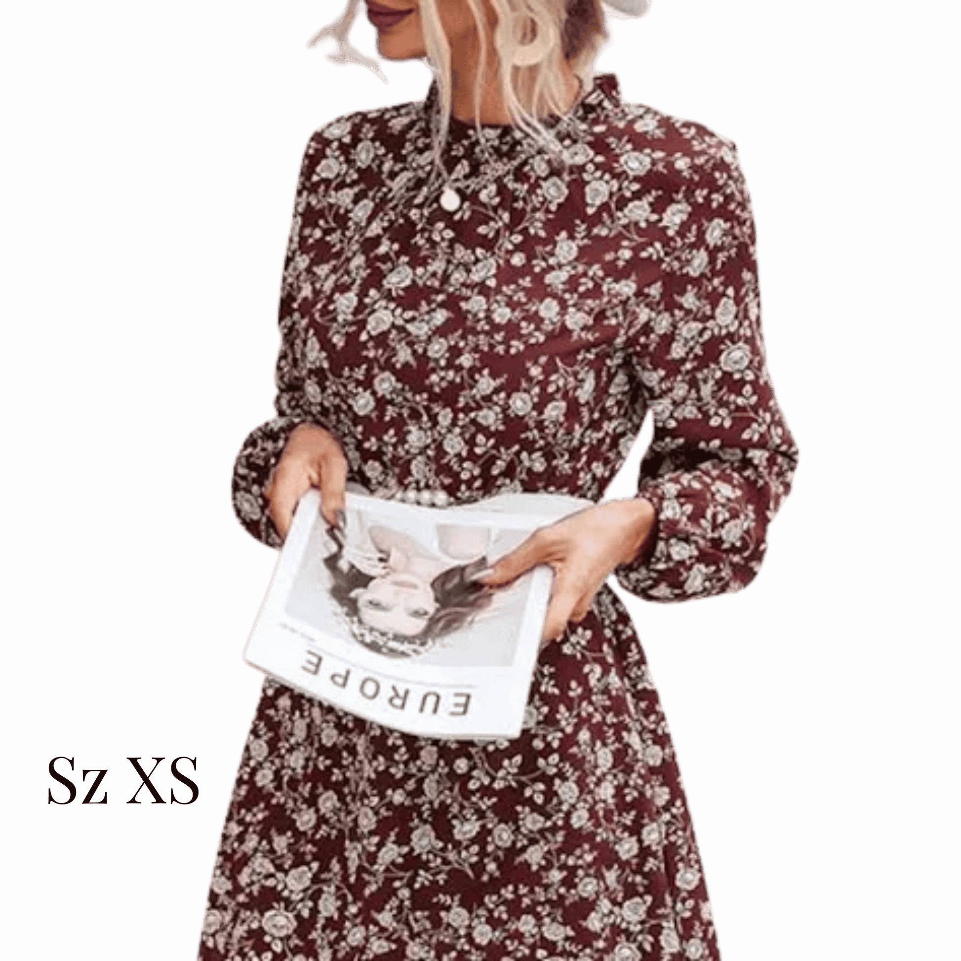 Woman wearing a floral dress holding a magazine against a red background