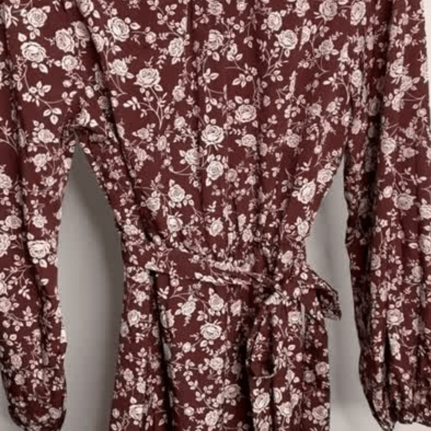 Maroon dress with white floral pattern on a plain background