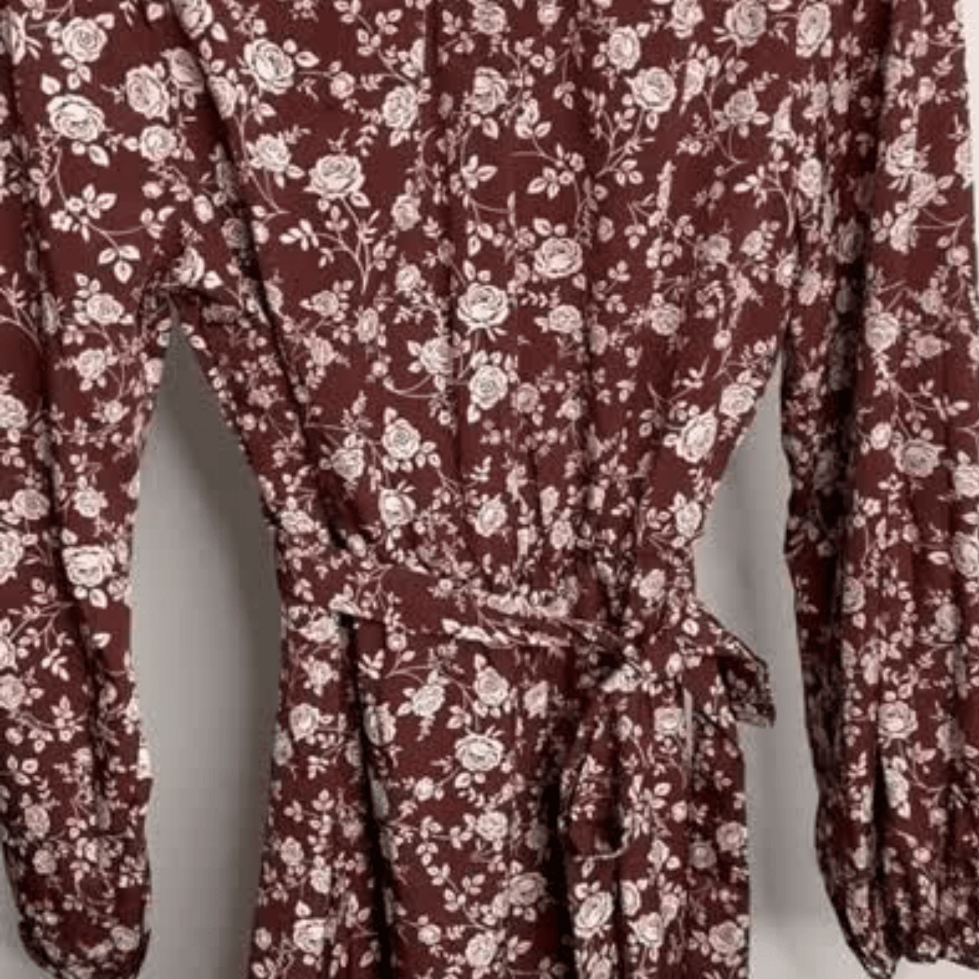 Maroon dress with white floral pattern on a plain background