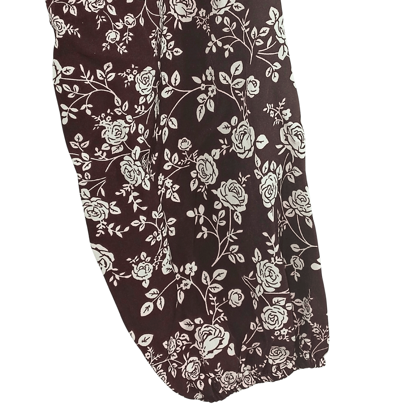 Floral patterned fabric with white flowers on a dark background