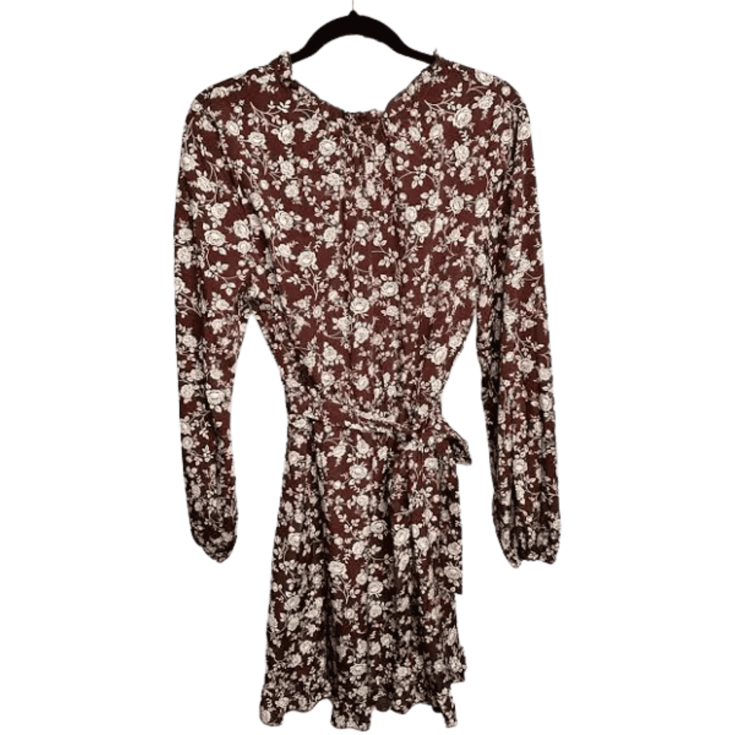 Floral dress with long sleeves on a hanger against a white background