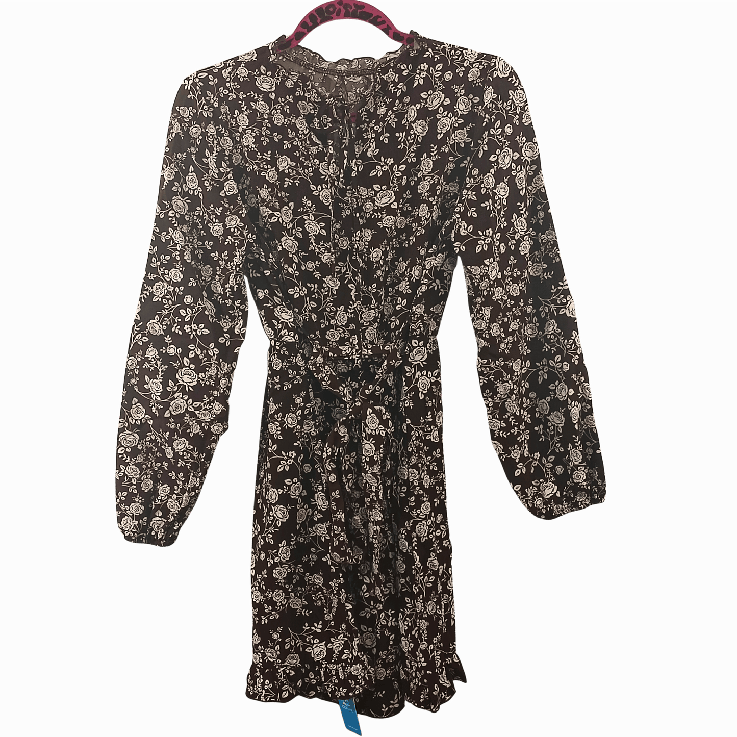 Floral dress on a hanger against a dark background