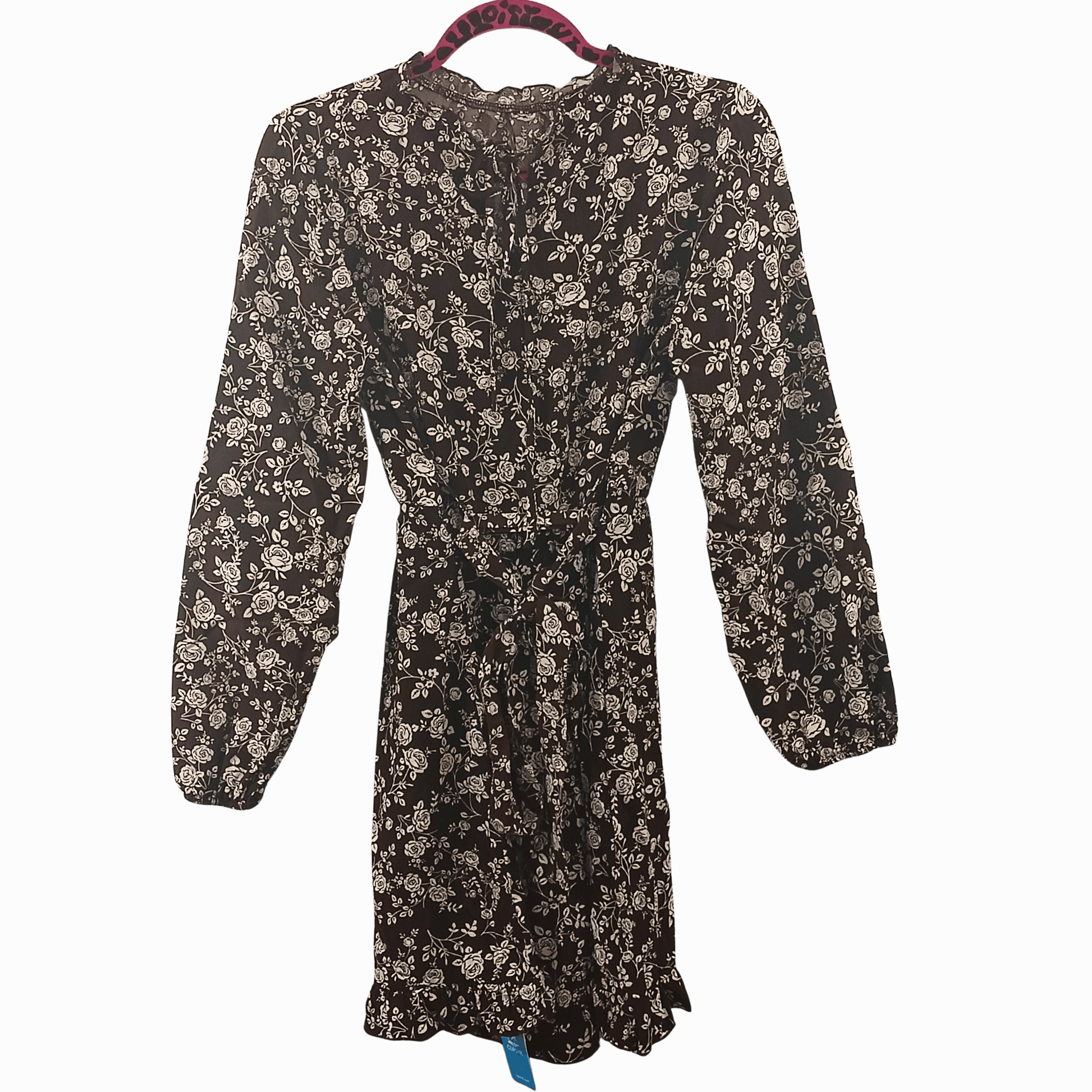 Floral dress on a hanger against a dark background