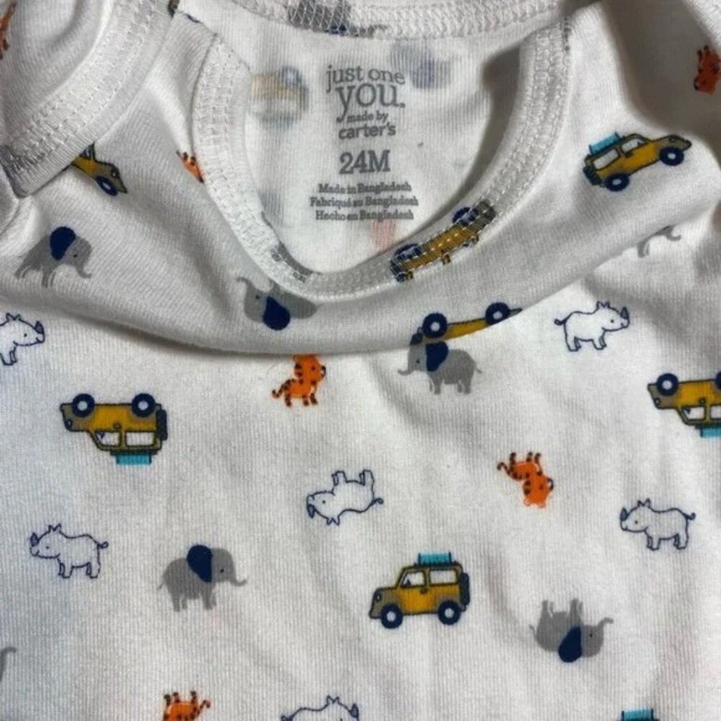 Baby onesie with animal and vehicle pattern, Carter's label visible