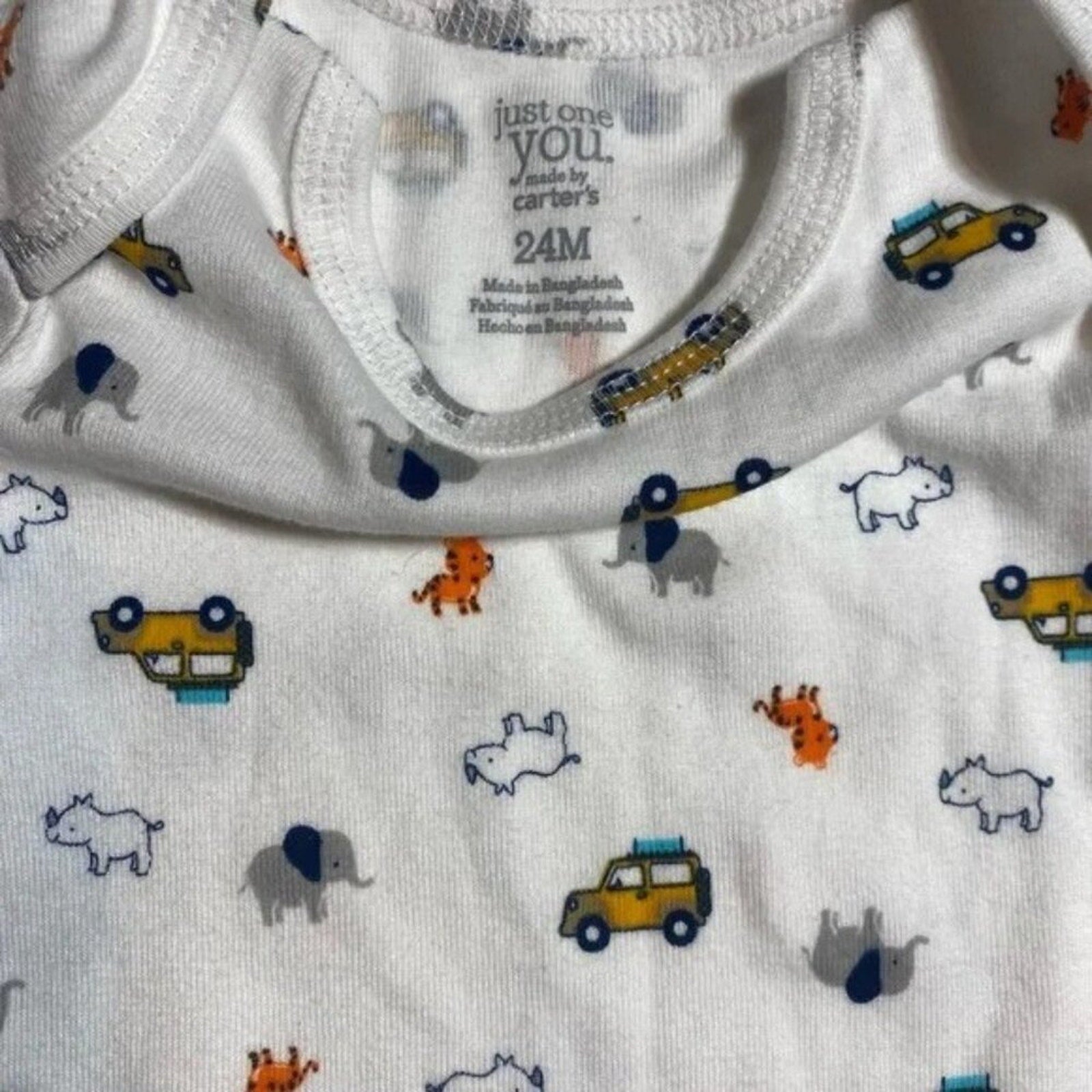 Baby onesie with animal and vehicle pattern, Carter's label visible
