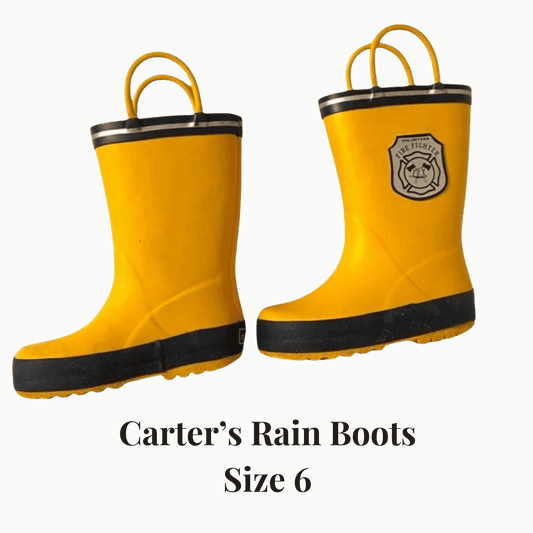 Yellow rain boots with black soles on a gray background, featuring the Carter's brand.