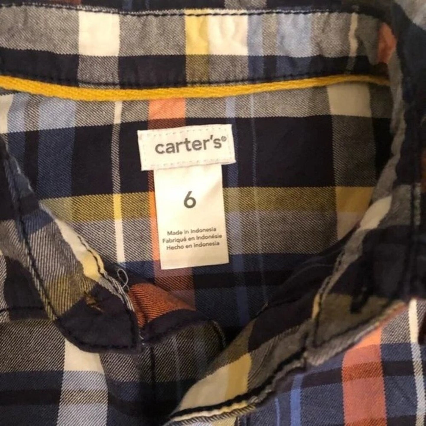 Plaid shirt with a Carter's size tag showing size 6