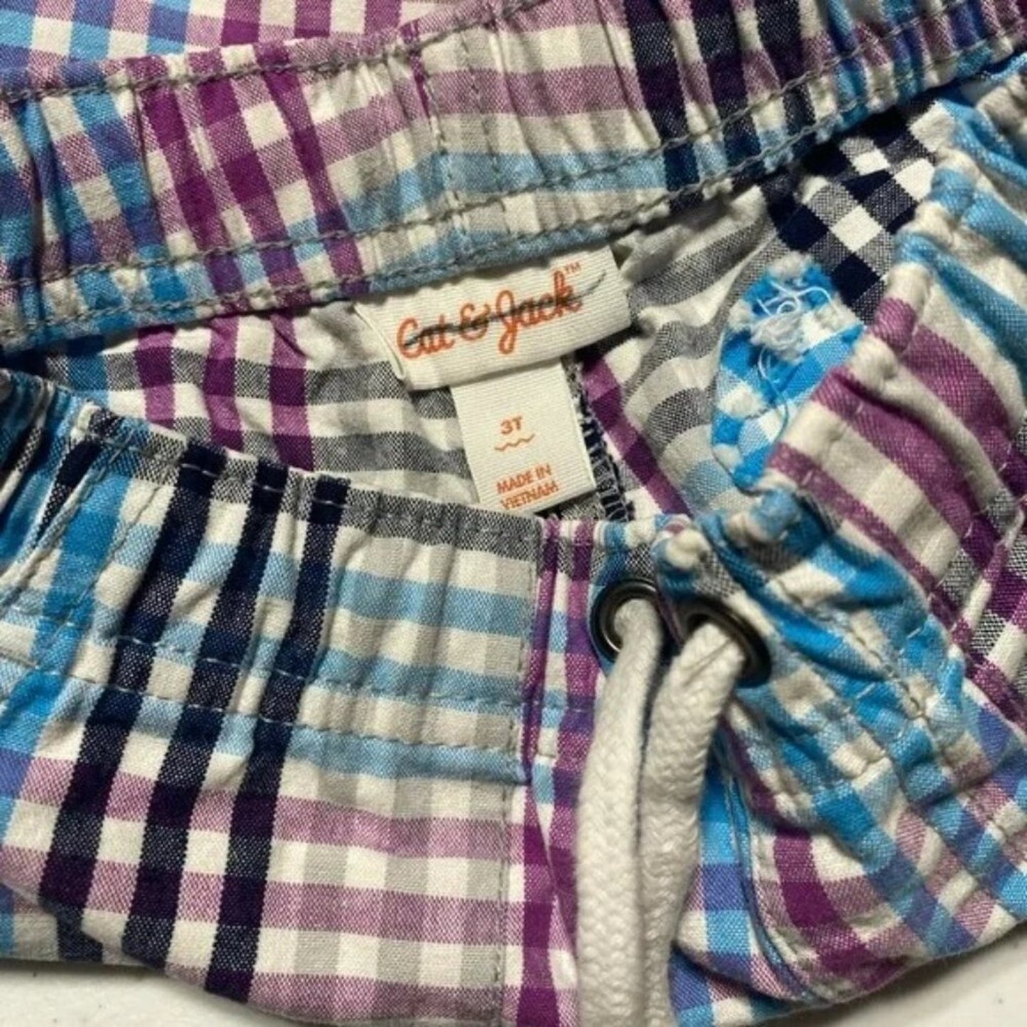 Plaid shorts with a visible brand label on a white background