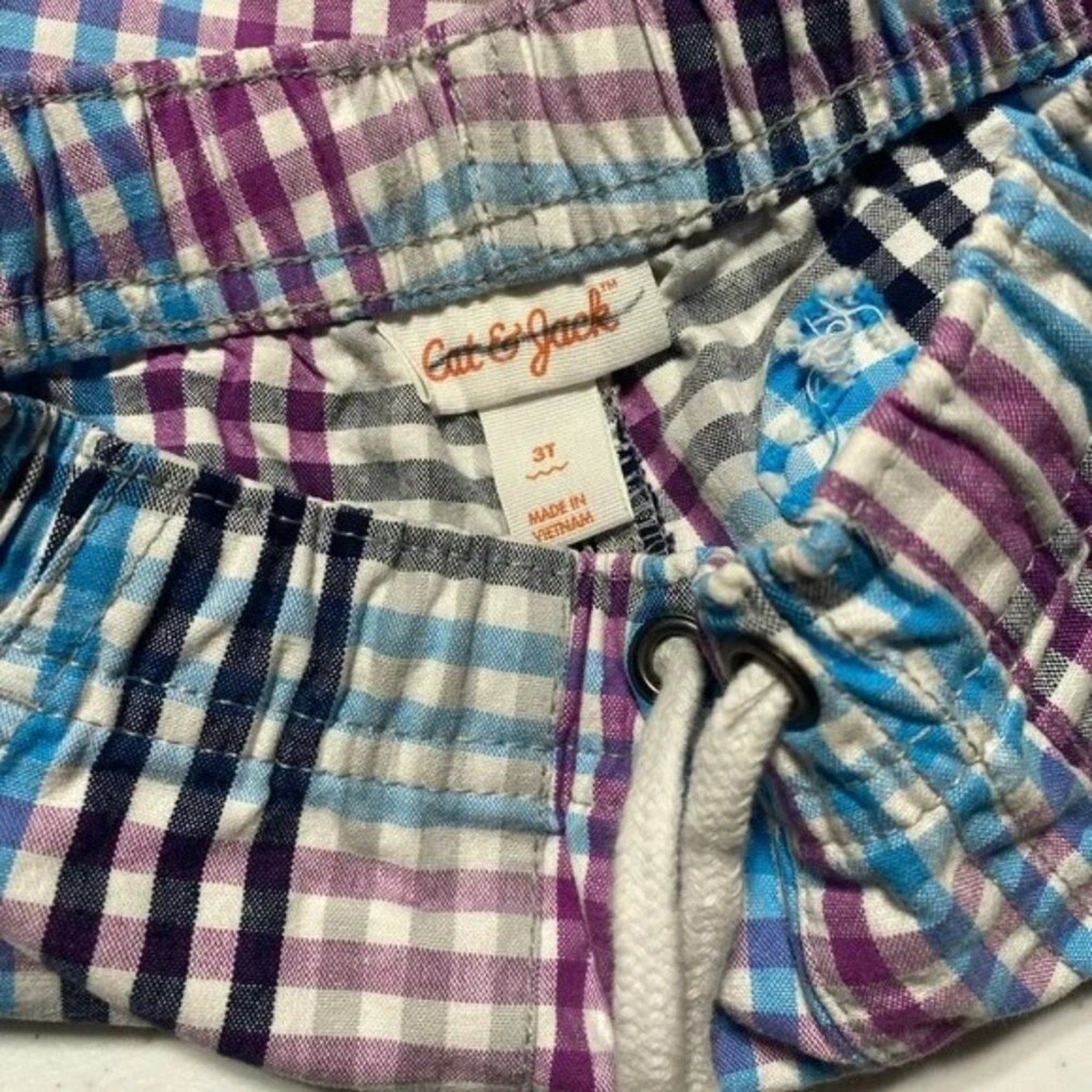Plaid shorts with a visible brand label on a white background