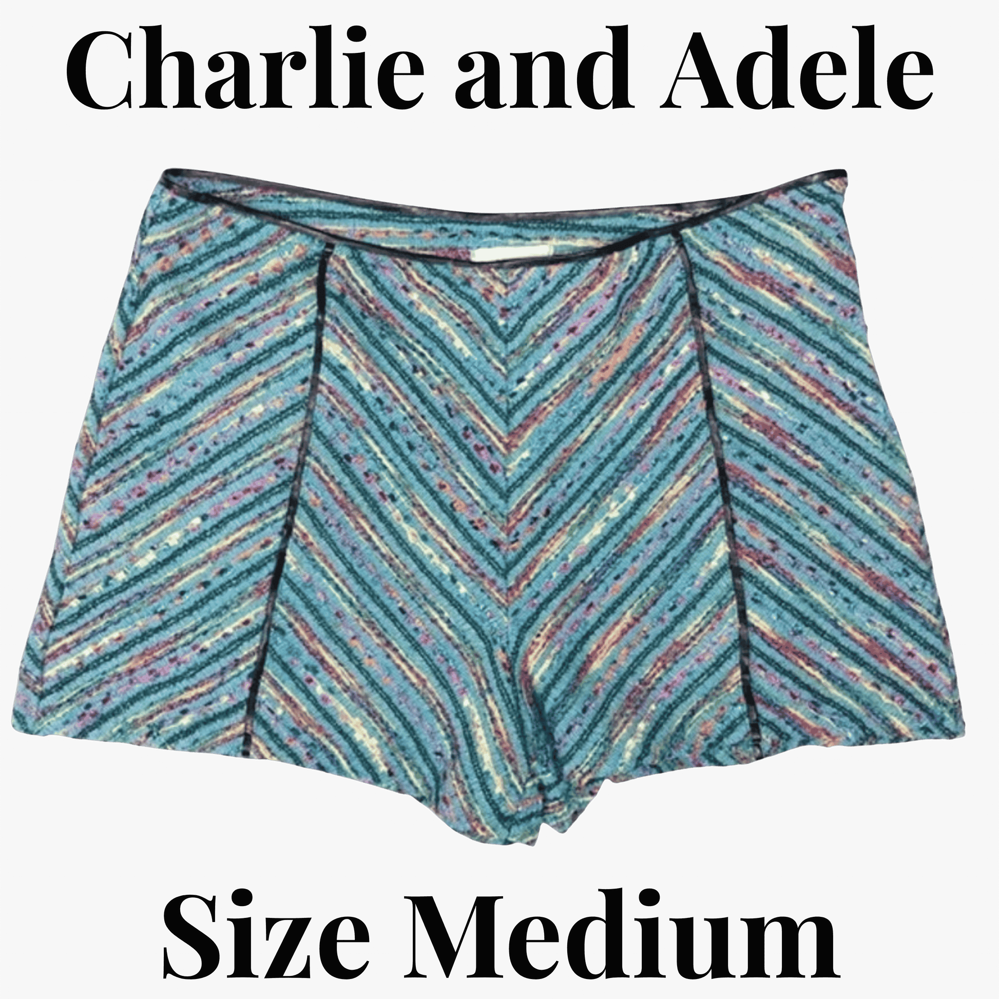 Multicolored striped shorts on a black background with 'Charlie and Adele' branding.