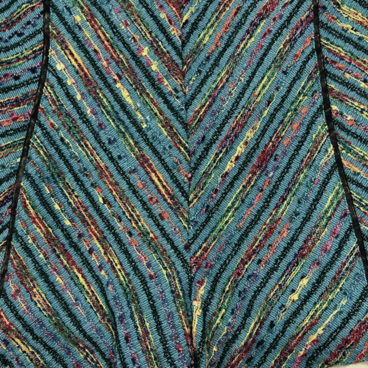 Close-up of a textured fabric with multicolored chevron pattern