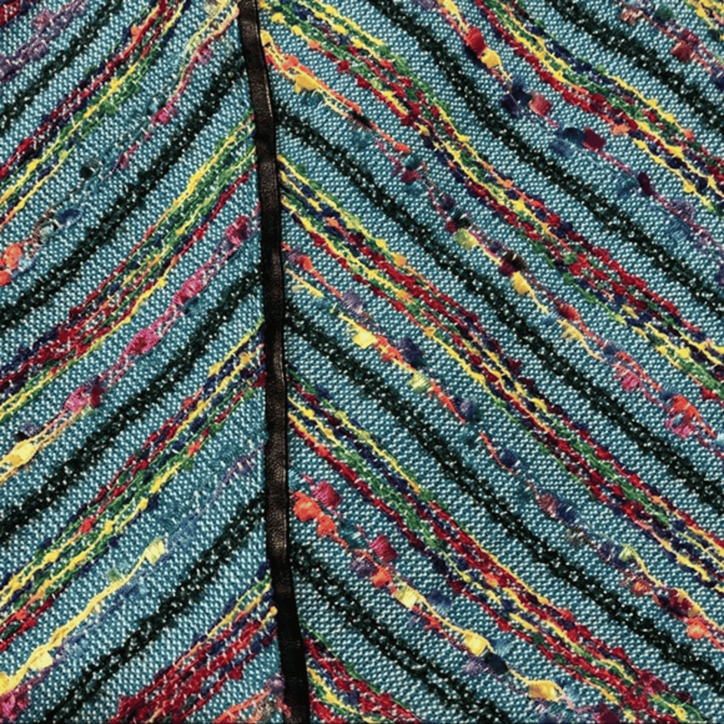 Close-up of a colorful leaf with multicolored veins on a blue background