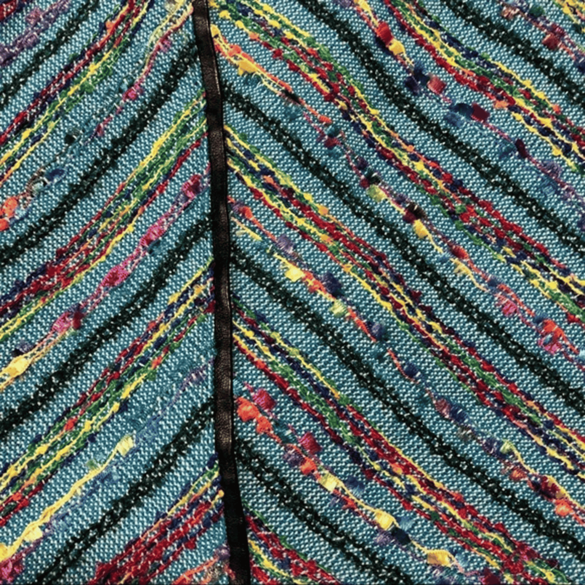 Close-up of a colorful leaf with multicolored veins on a blue background