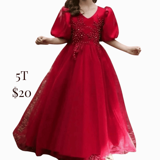 Red dress with embellishments on a dark background