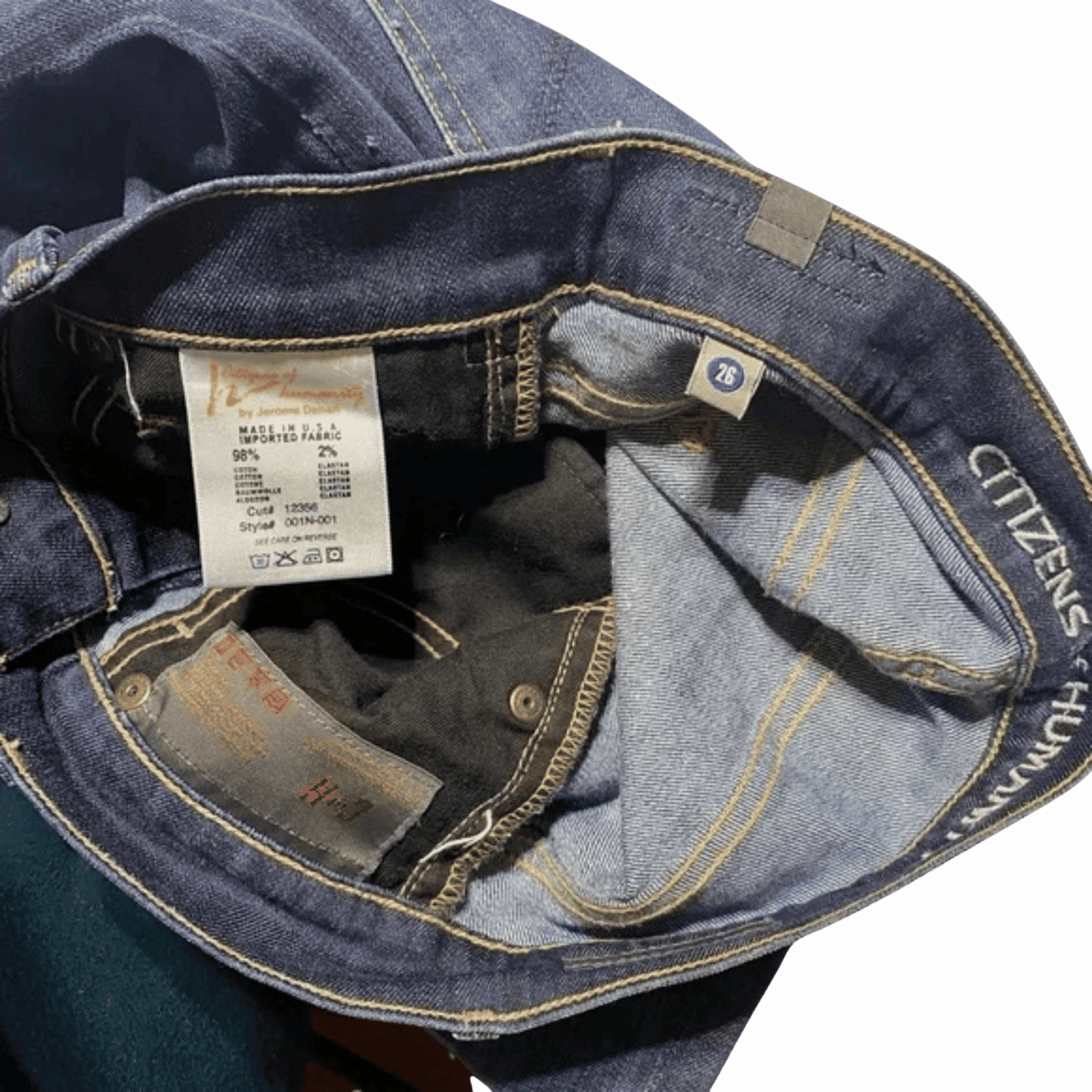 Close-up of a blue denim jacket with a brand label on a black background