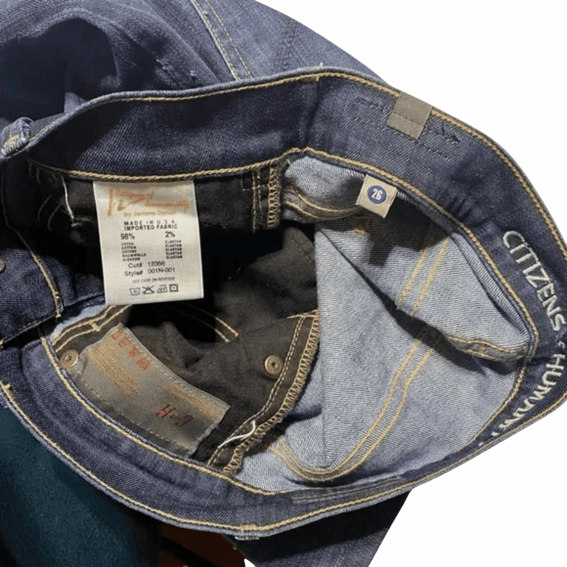 Close-up of a blue denim jacket with a brand label on a black background