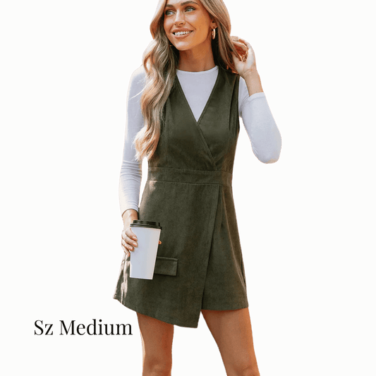 Woman wearing a green dress holding a coffee cup on a solid background