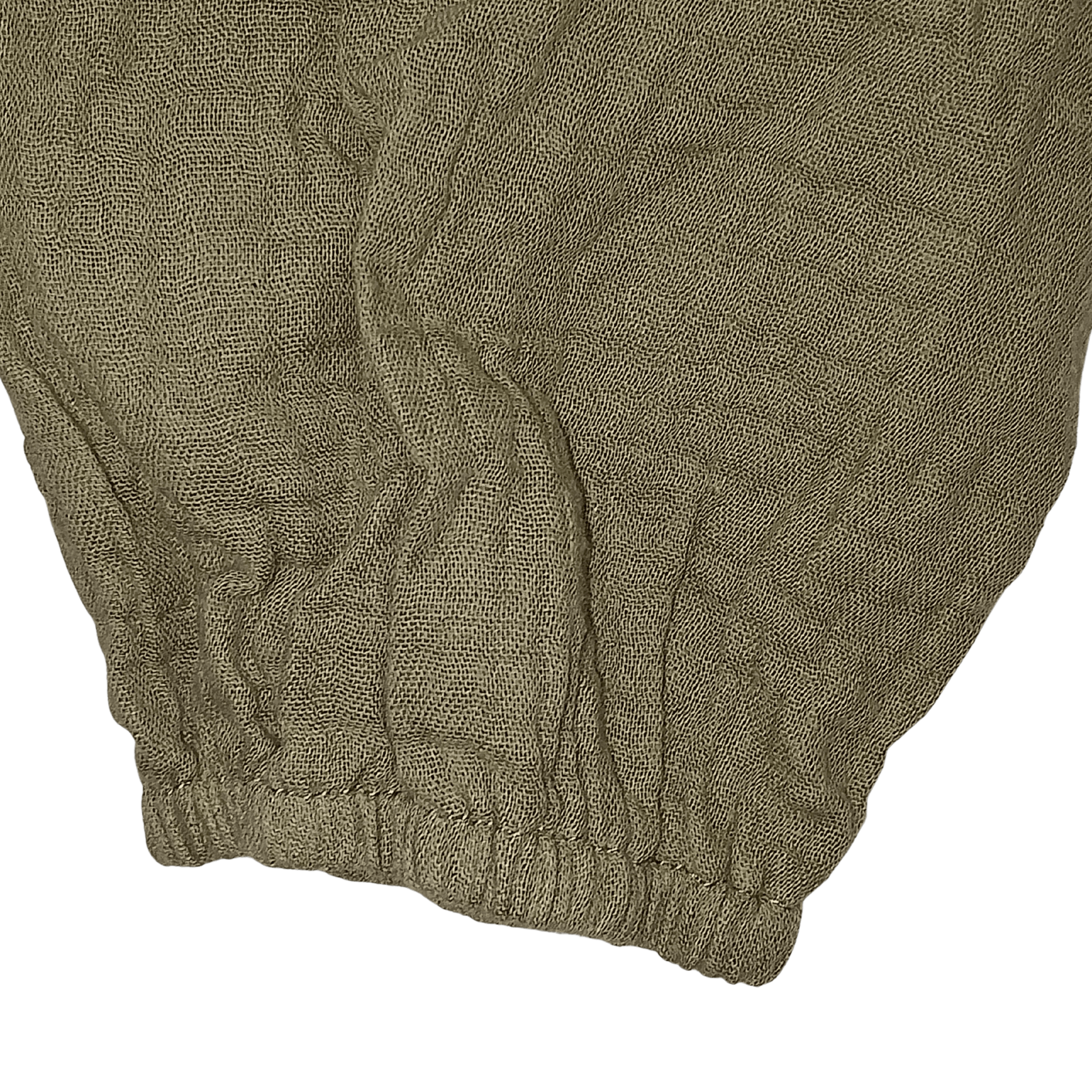 Close-up of a textured brown fabric with a brand name on a transparent background