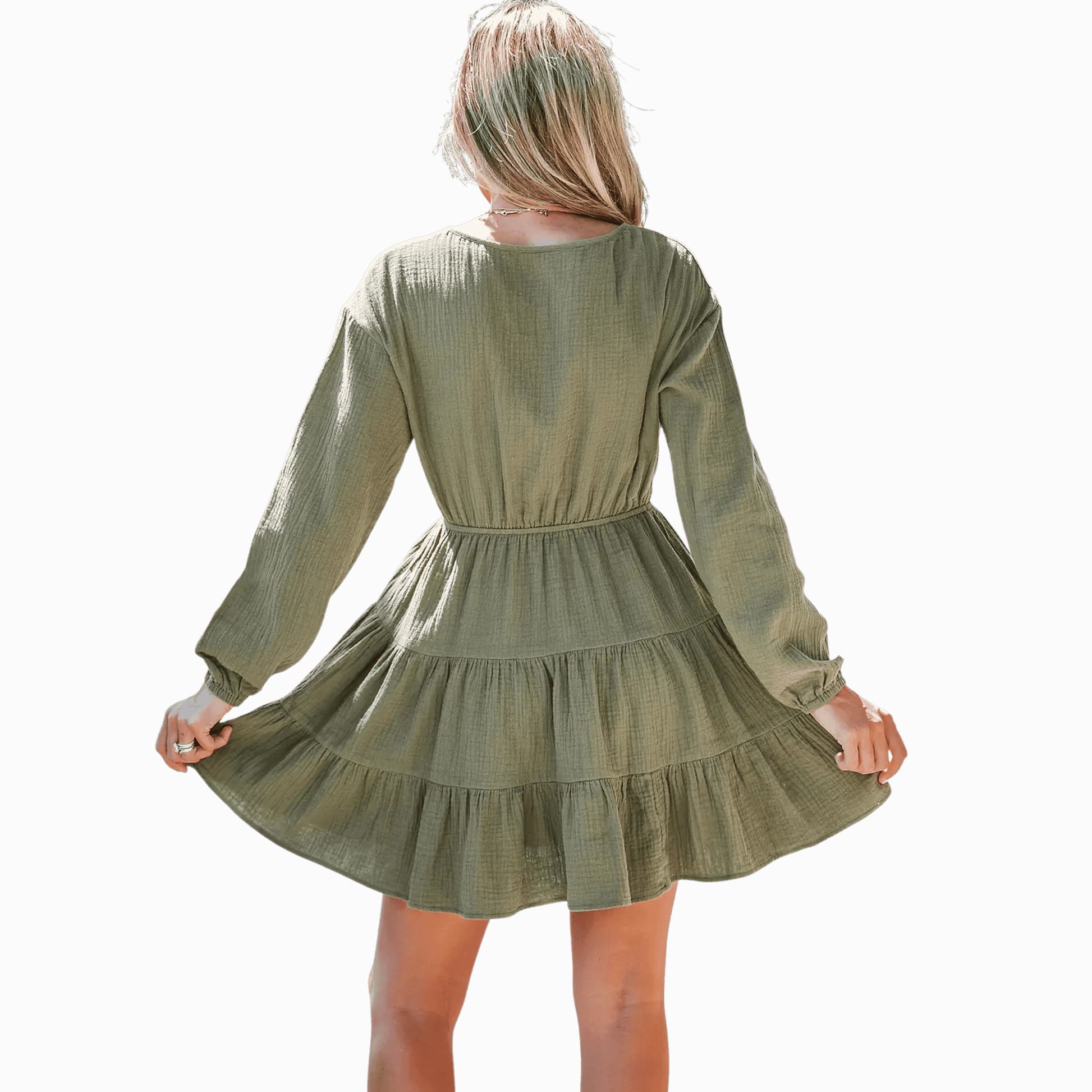 Green dress with long sleeves and a tiered skirt on a plain background