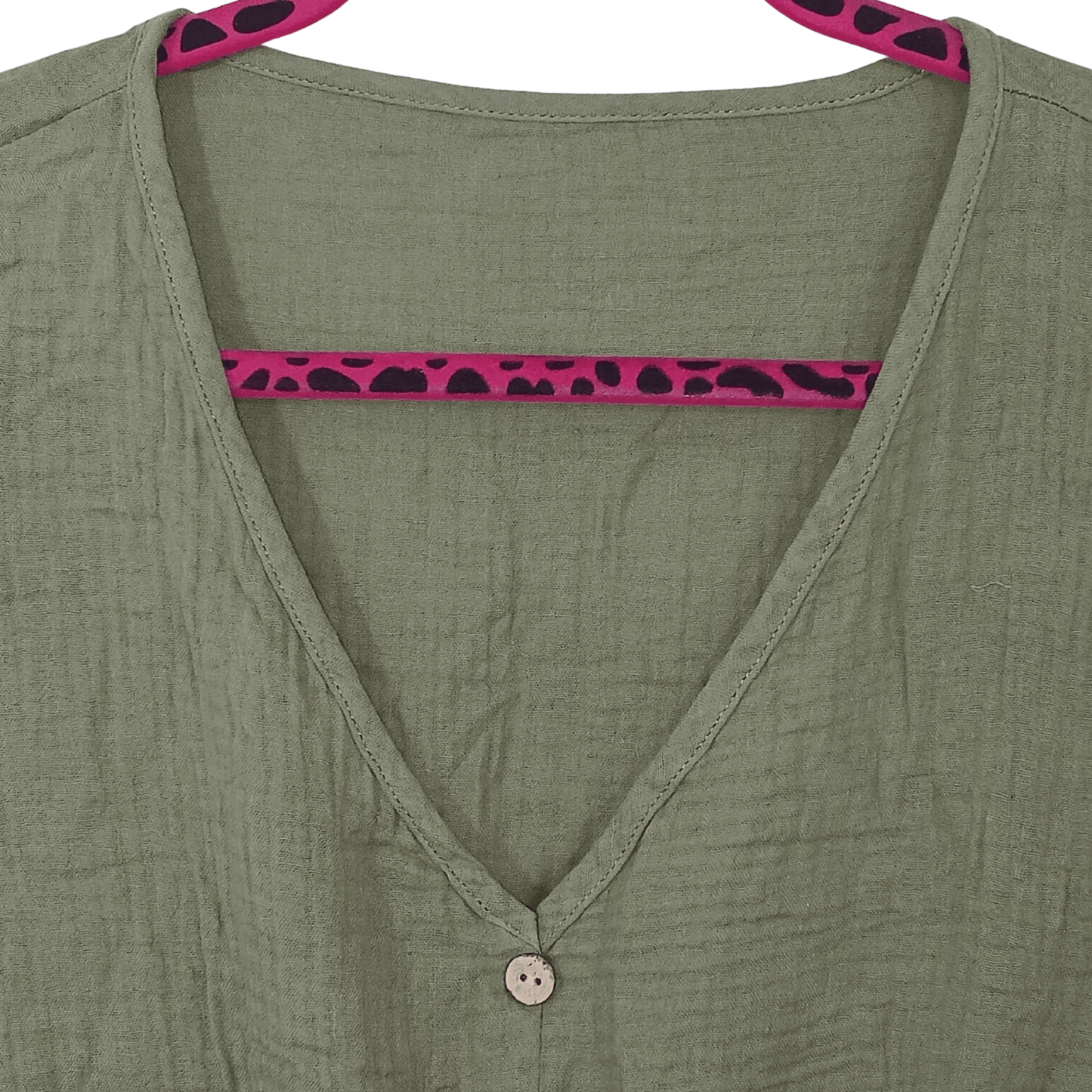 Green shirt with pink and black trim on a green background