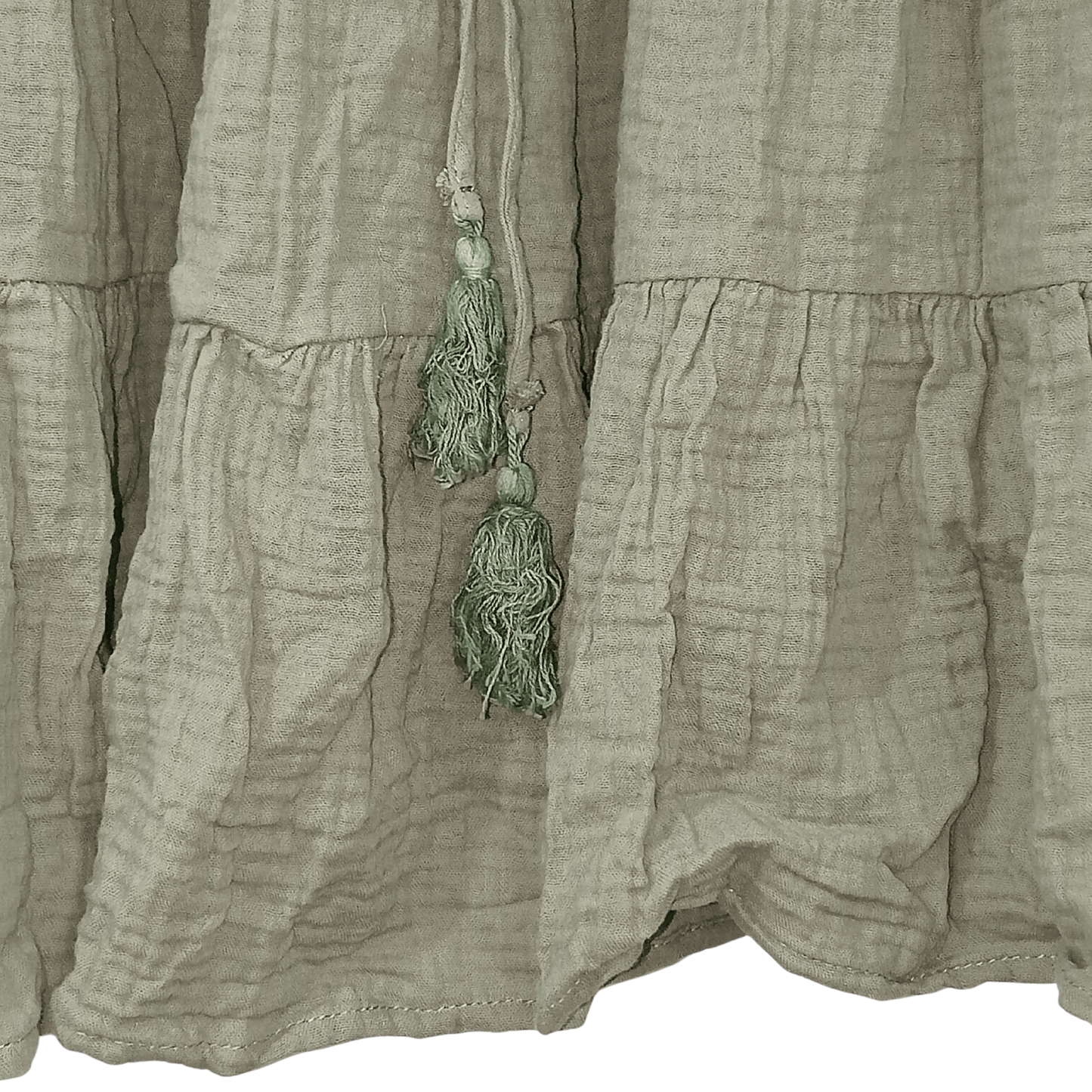 Light brown fabric with a decorative tassel hanging from it