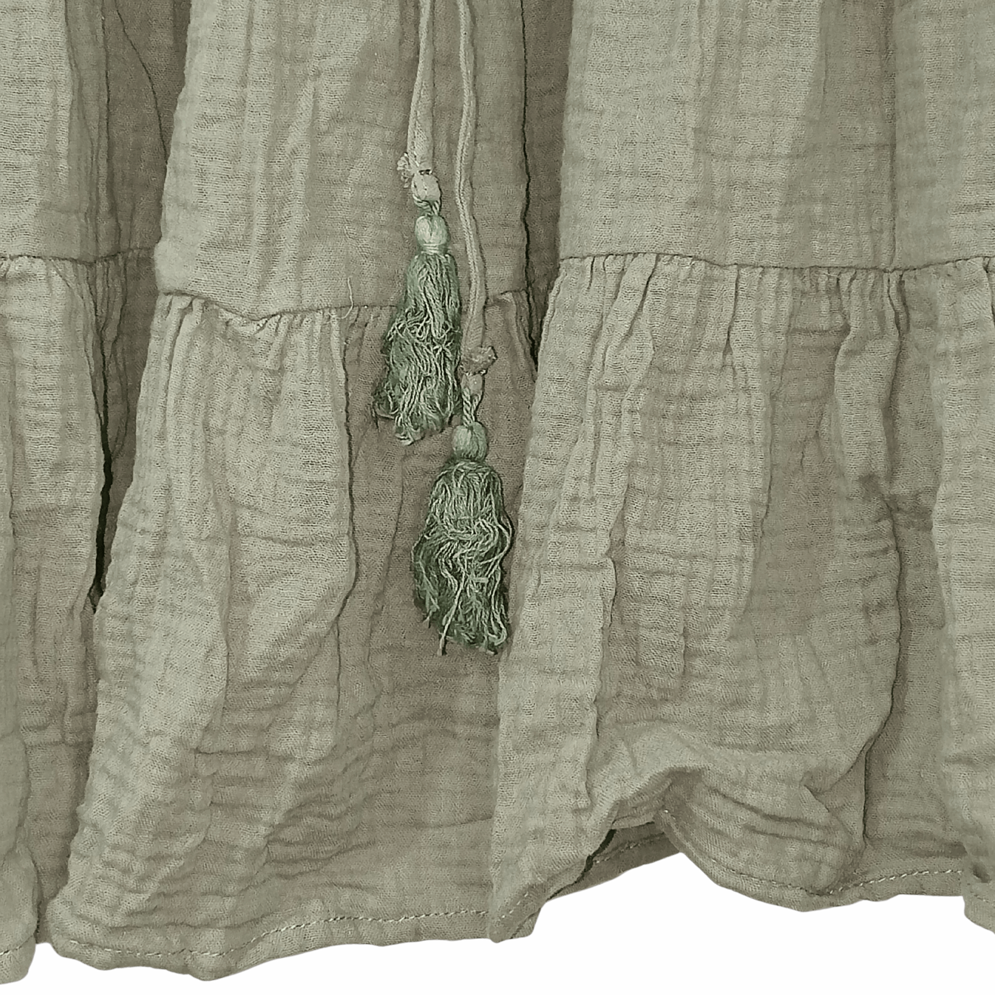 Light brown fabric with a decorative tassel hanging from it