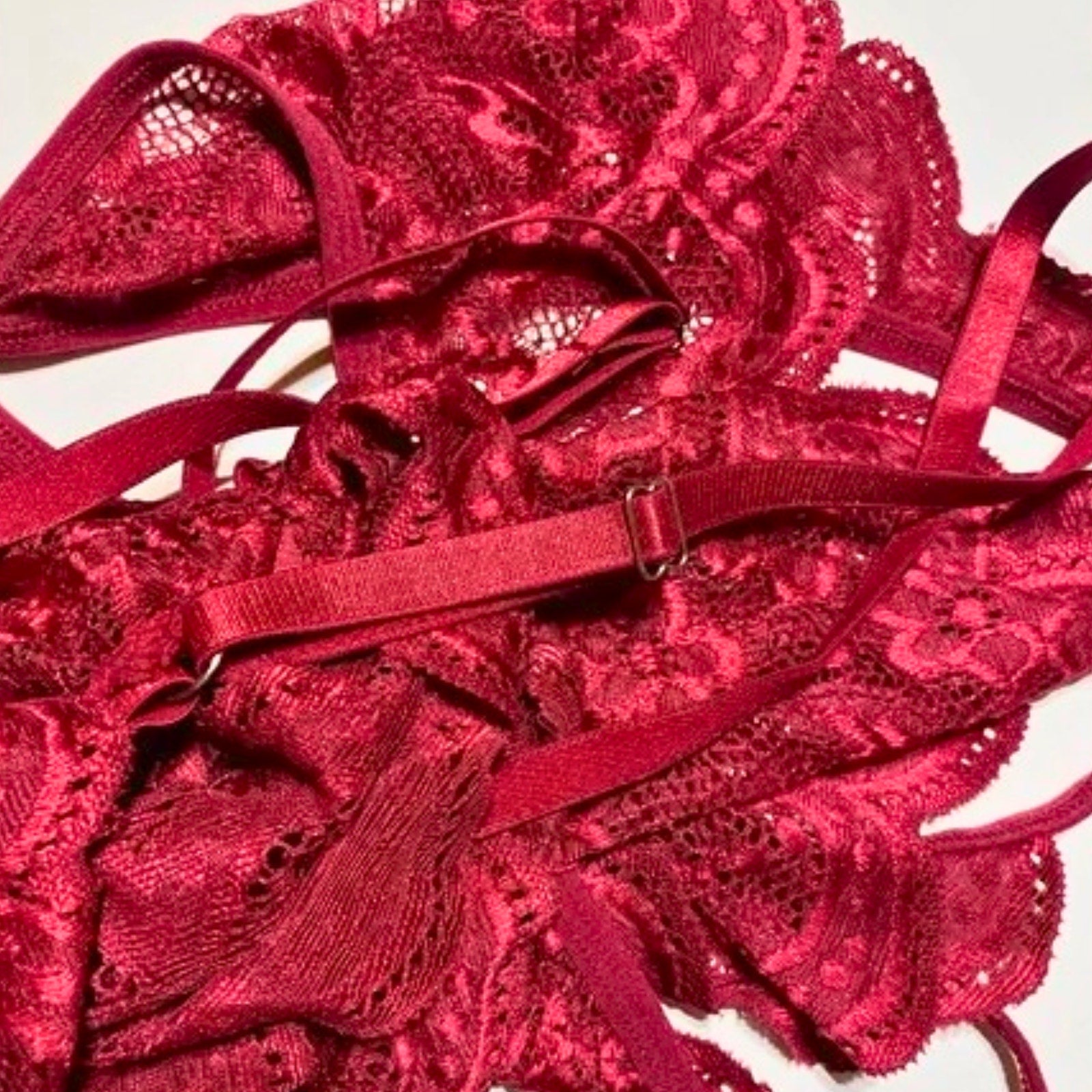 Red lace lingerie set on a white background