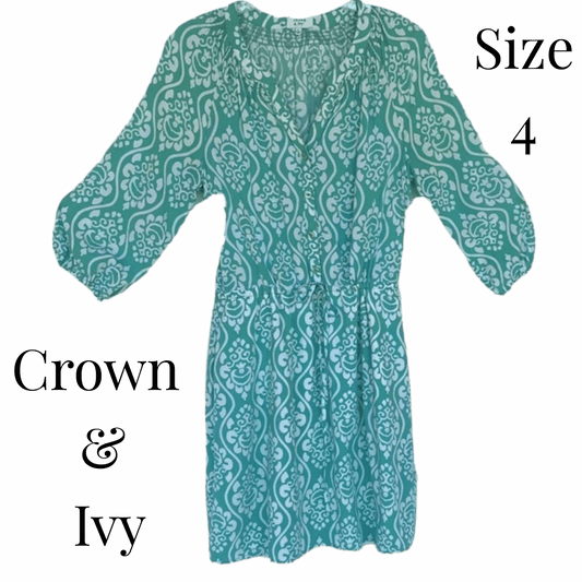 Green patterned dress on a blue background with 'Crown & Ivy' branding.