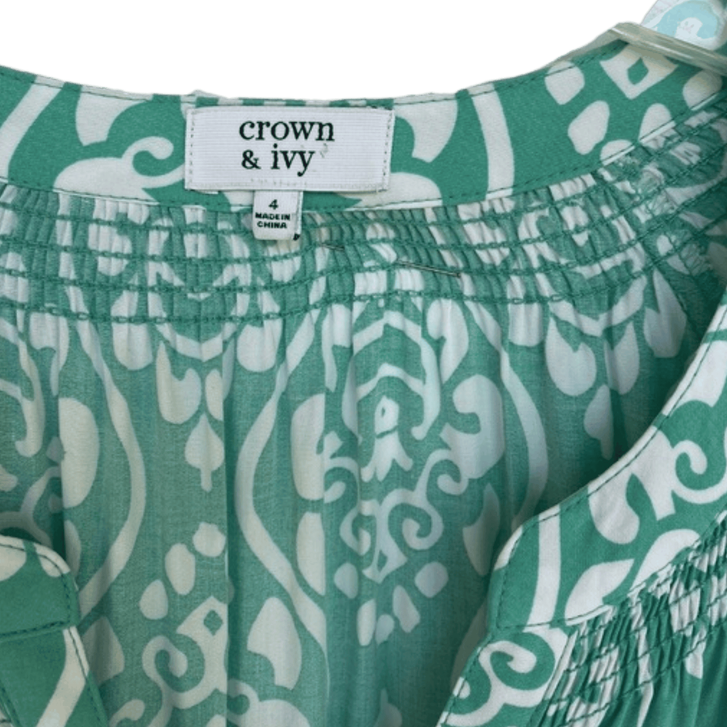 Green and white patterned shorts with 'crown & ivy' label