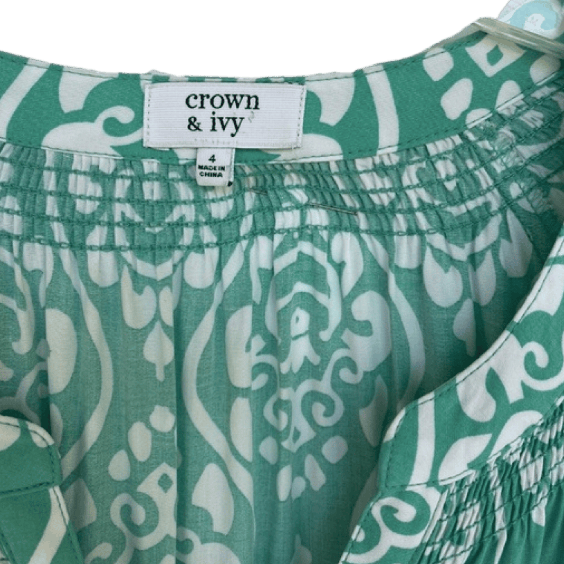 Green and white patterned shorts with 'crown & ivy' label