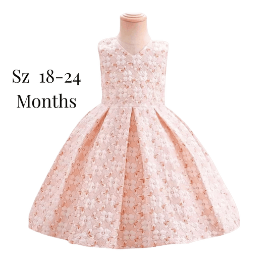 Children's dress on a mannequin with size label 'Sz 18-24 Months' on a green background