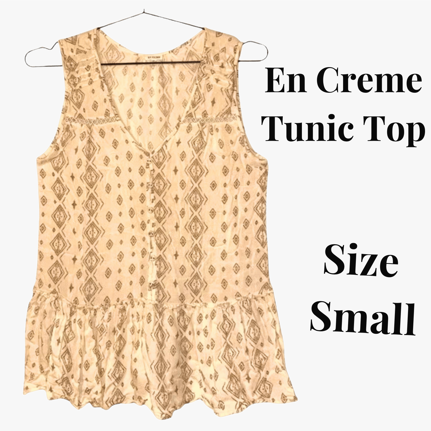 Beige patterned tunic top on a hanger with text indicating size small.