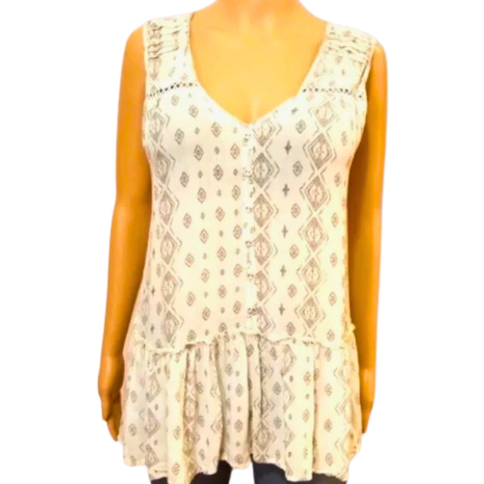 Beige sleeveless top with pattern on a mannequin against a white background