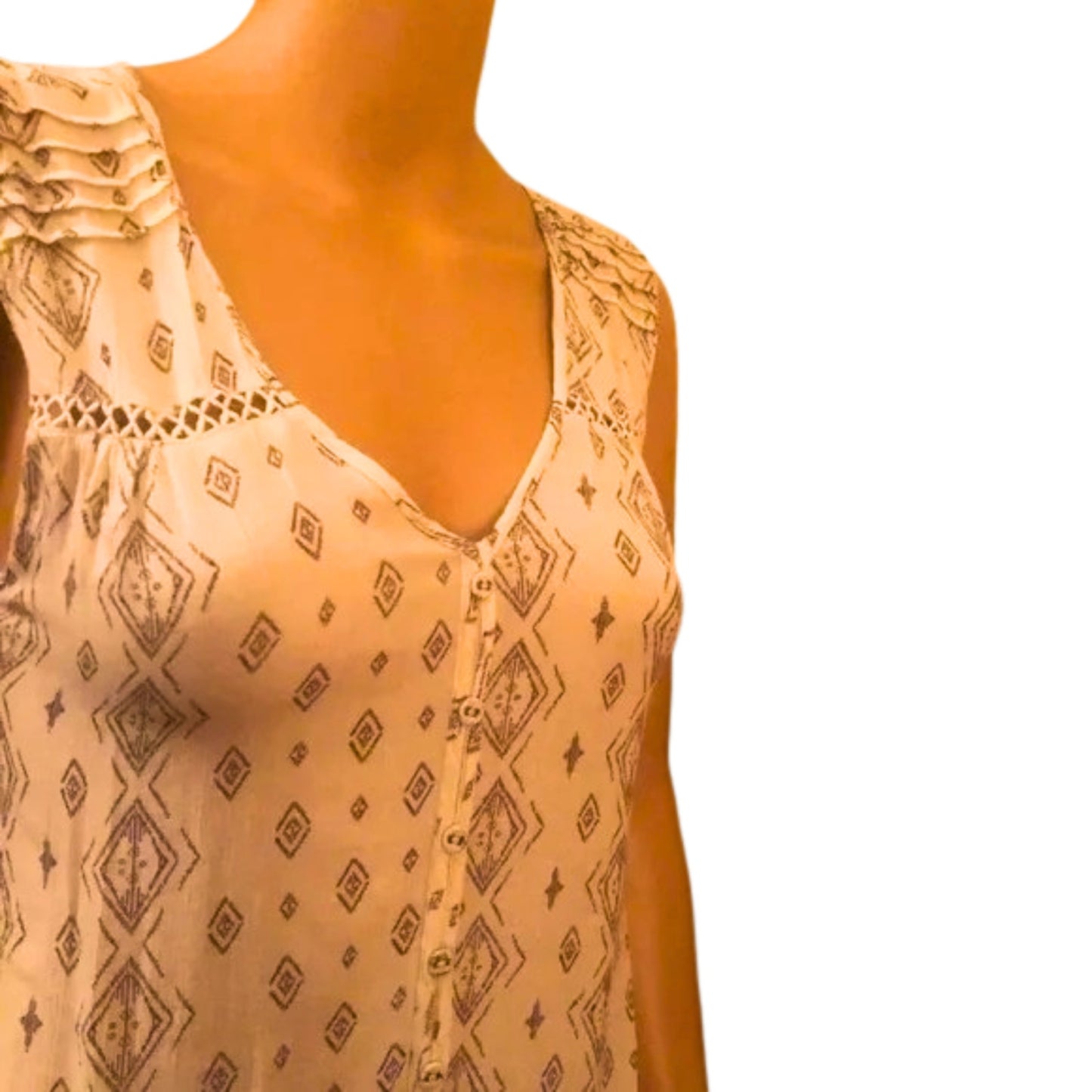 Beige sleeveless top with black geometric pattern on a mannequin against a white background