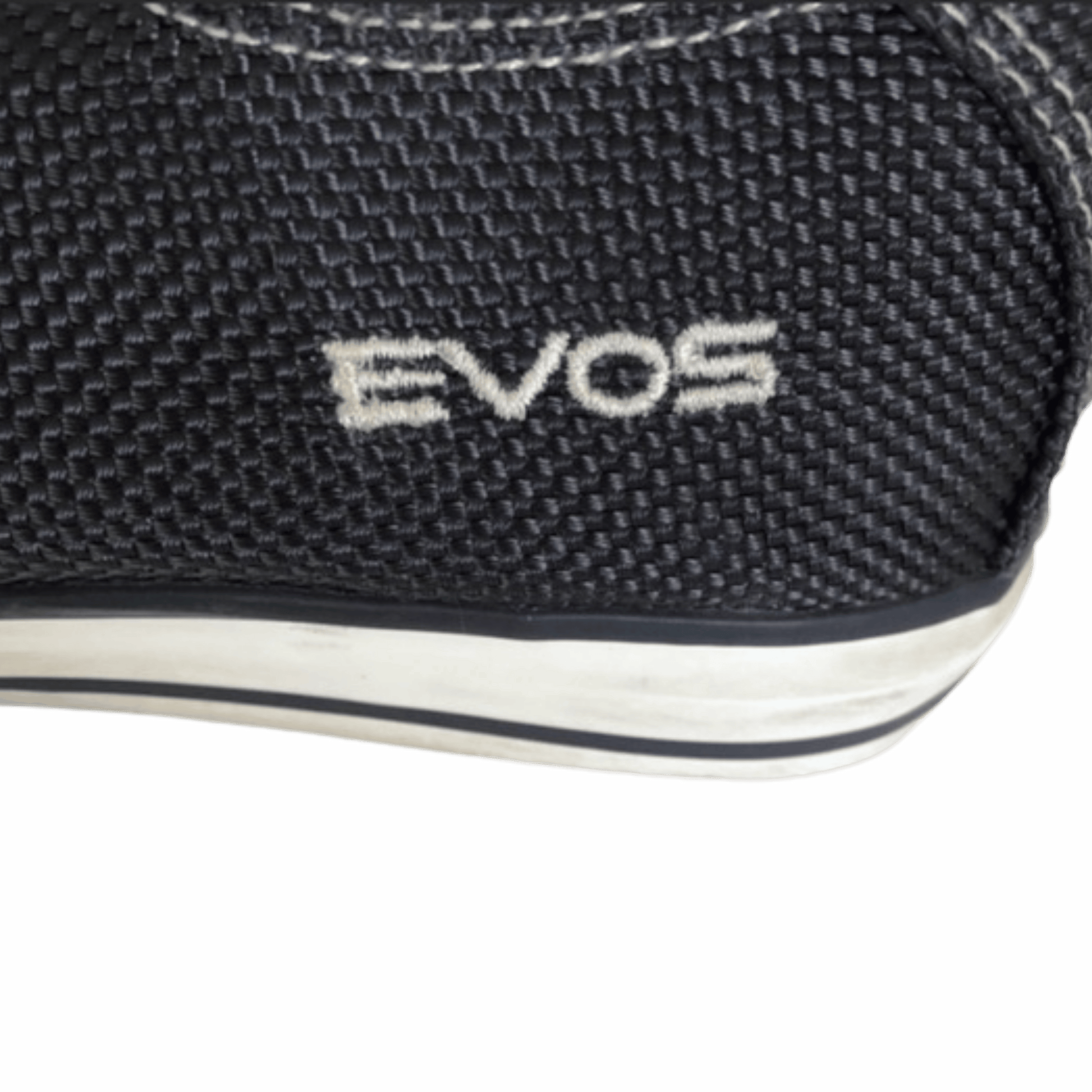 Close-up of a black shoe with 'EVOS' branding on a white background