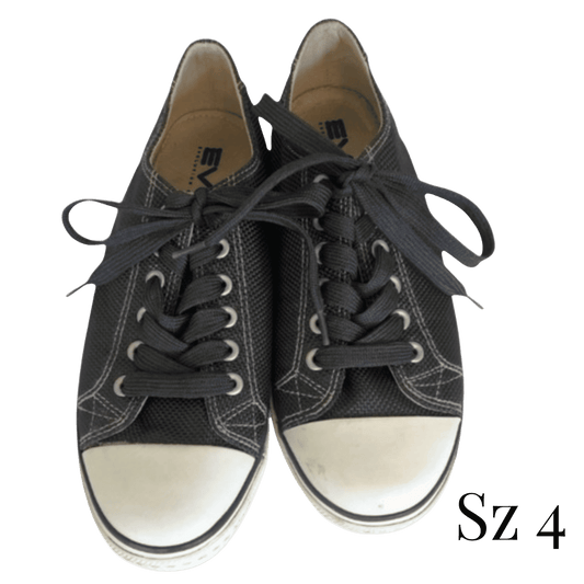 Pair of black sneakers with white soles on a transparent background