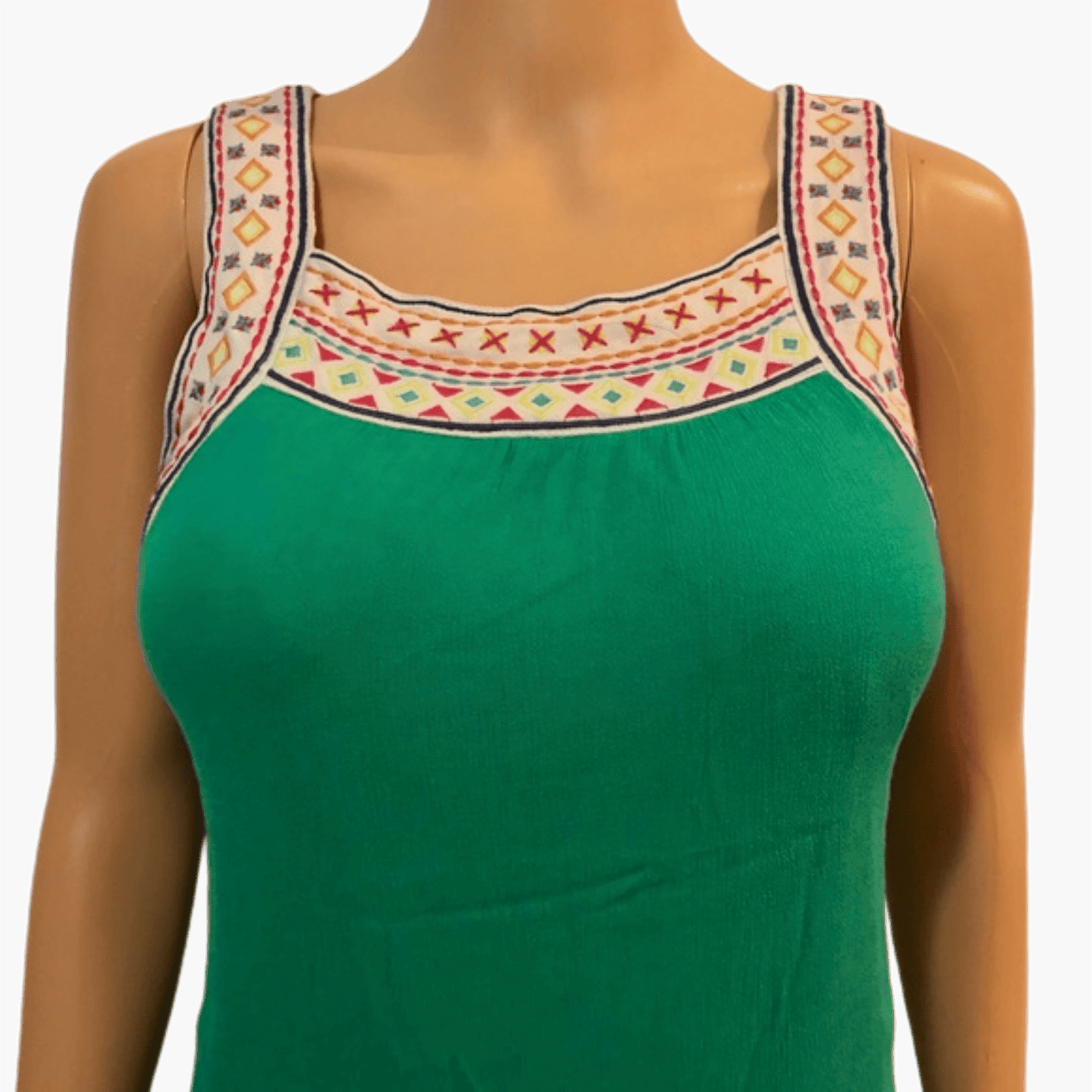Green top with embroidered straps on a mannequin against a gray background