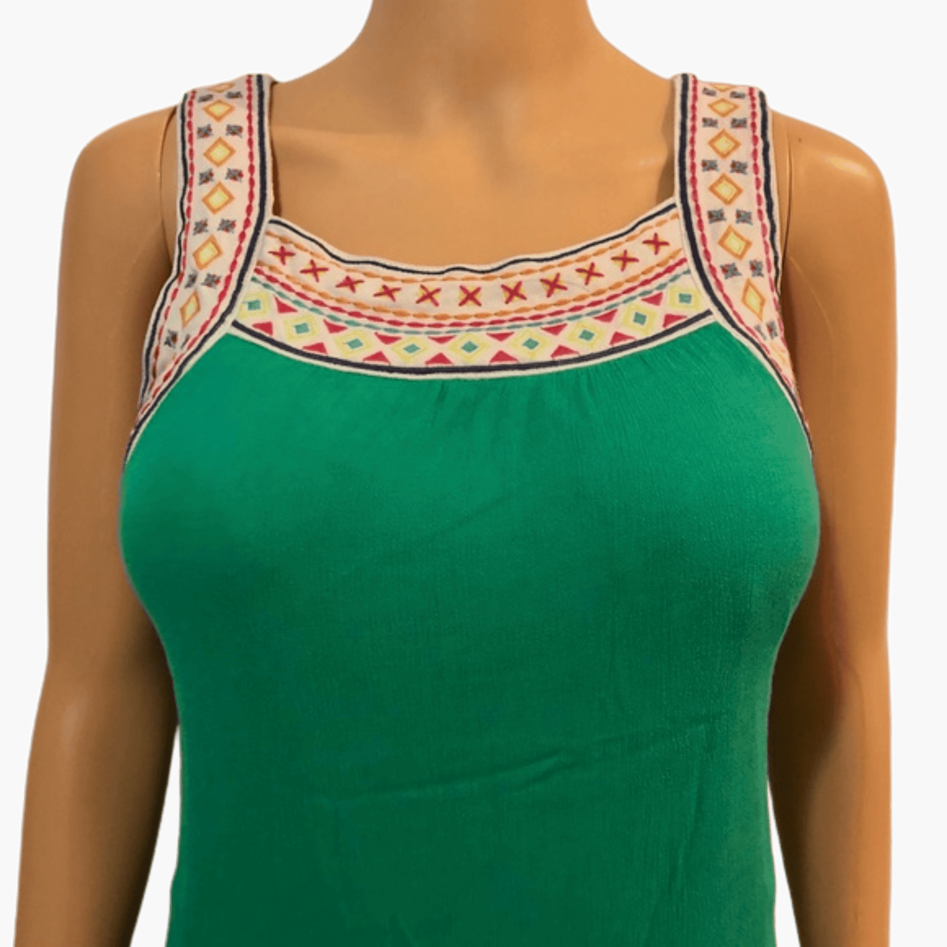 Green top with embroidered straps on a mannequin against a gray background