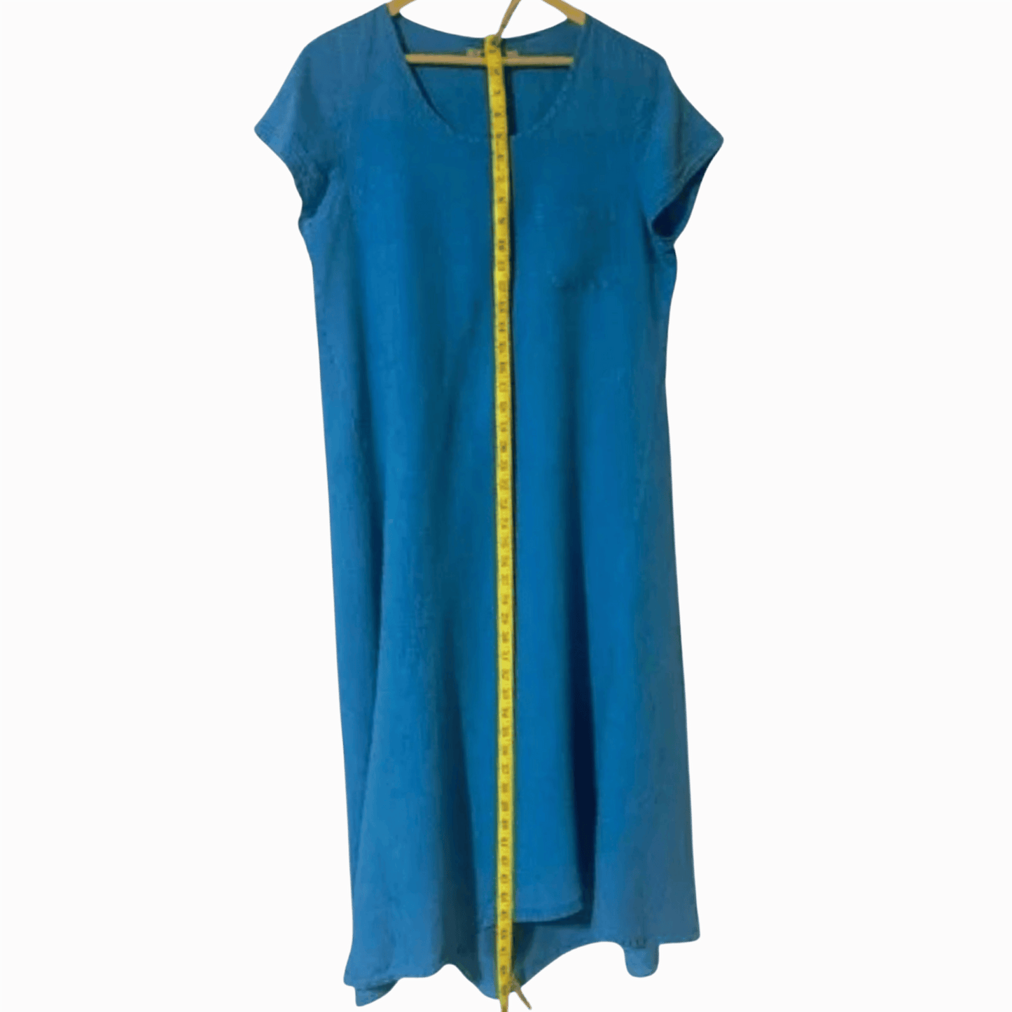 Blue dress on a hanger with a yellow measuring tape running along its length against a brown background