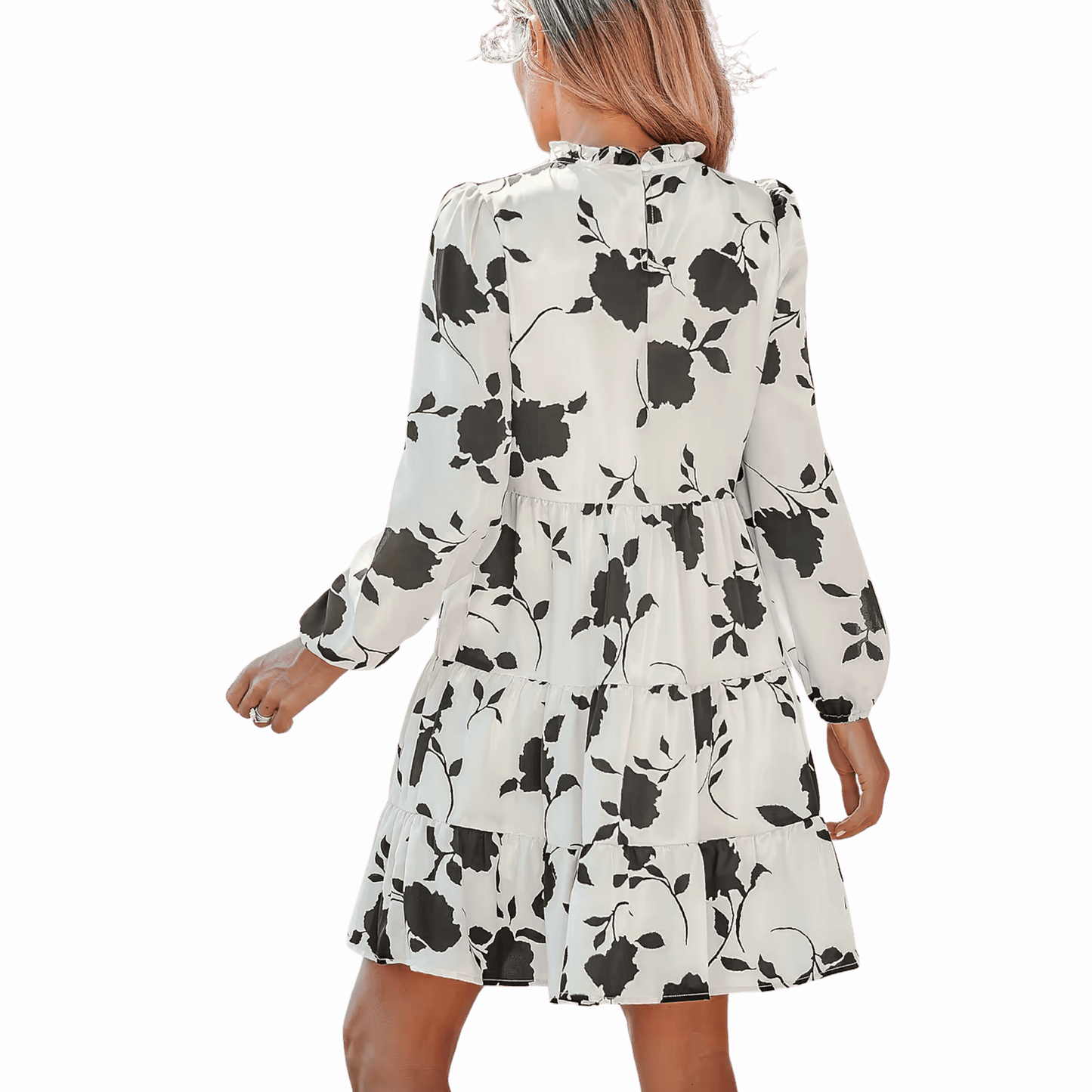 Woman wearing a white dress with black floral pattern on a red background