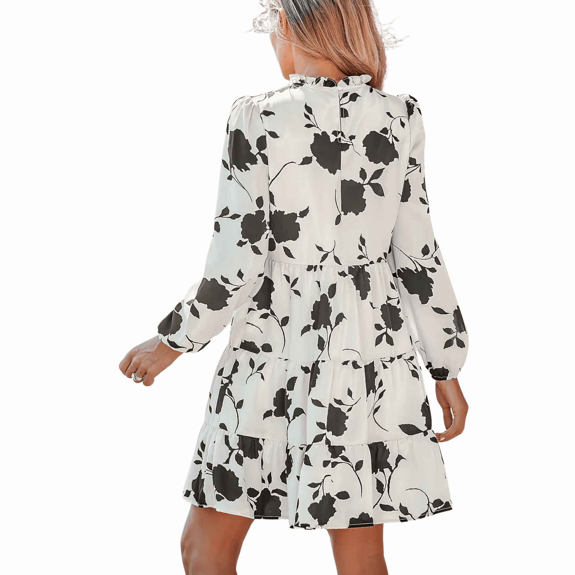 Woman wearing a white dress with black floral pattern on a red background