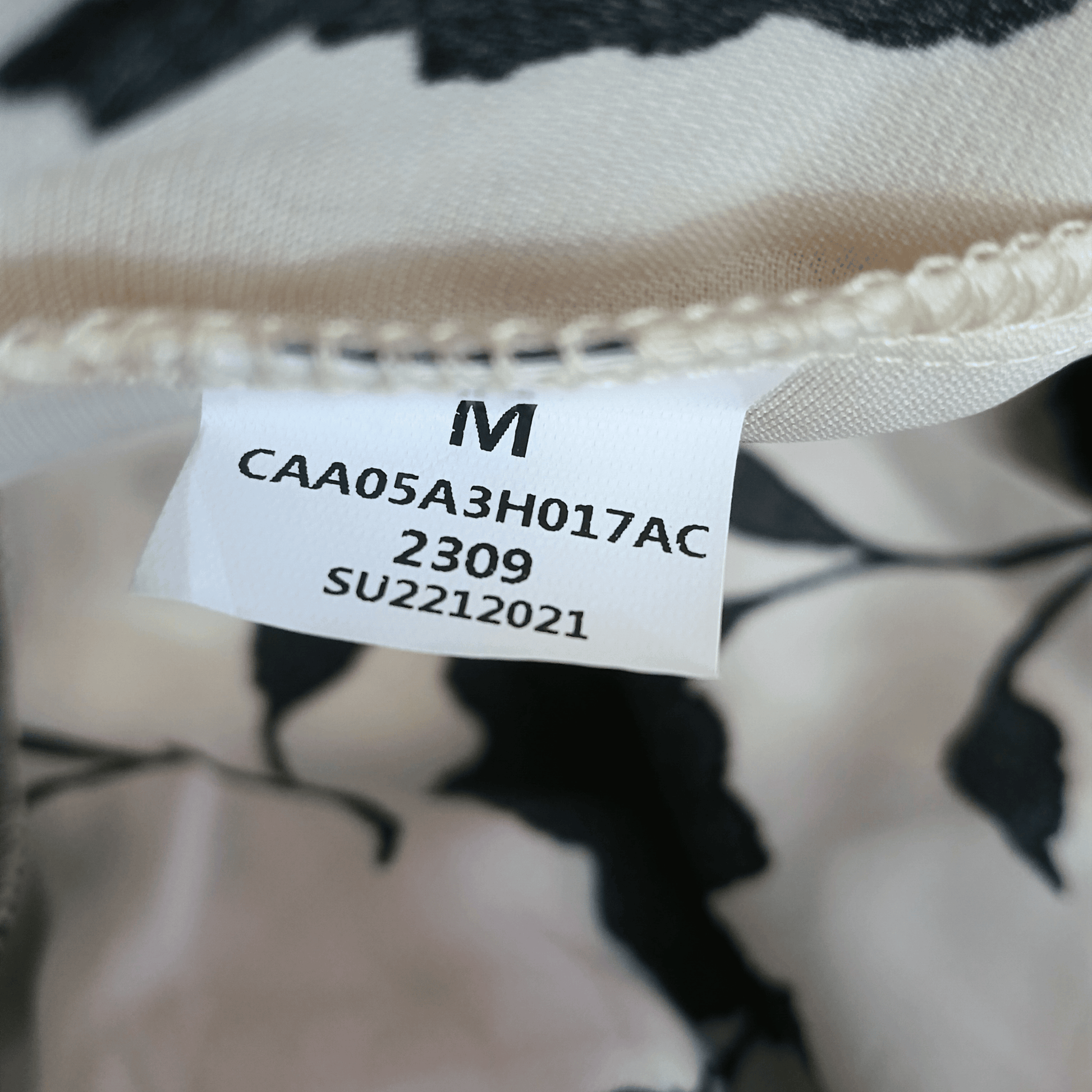 Close-up of a label on a garment with text and numbers