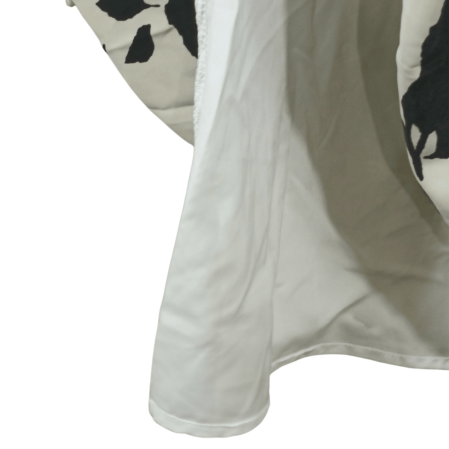 Close-up of a white fabric with black floral patterns on a transparent background