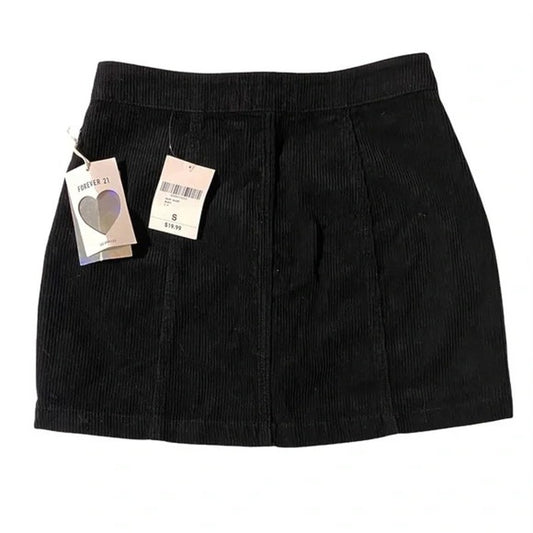 Black corduroy skirt with tags on a white background