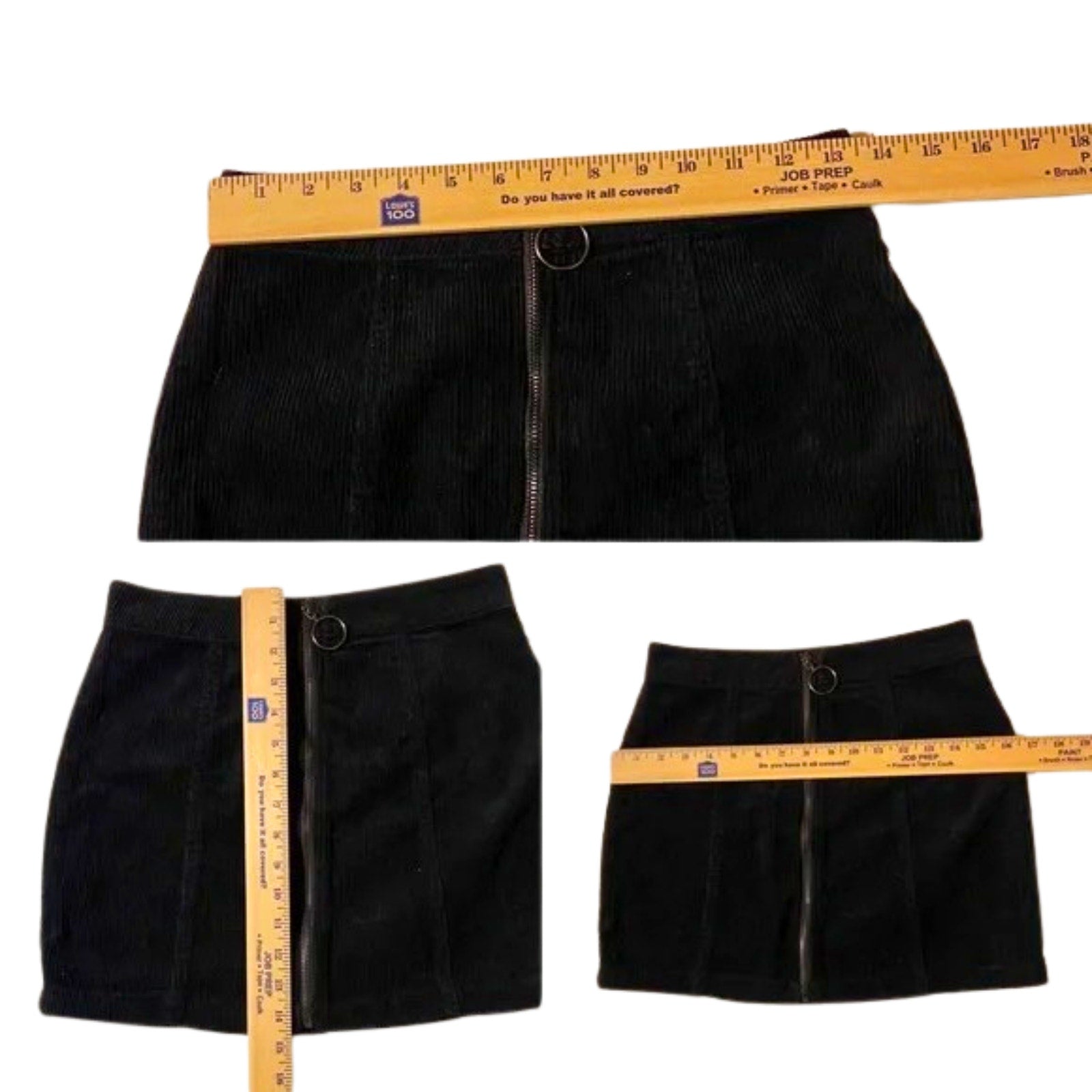 Black skirt with a measuring tape showing its width on a white background