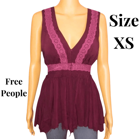 Mannequin wearing a maroon lace top with 'Free People' branding and size 'XS' text.